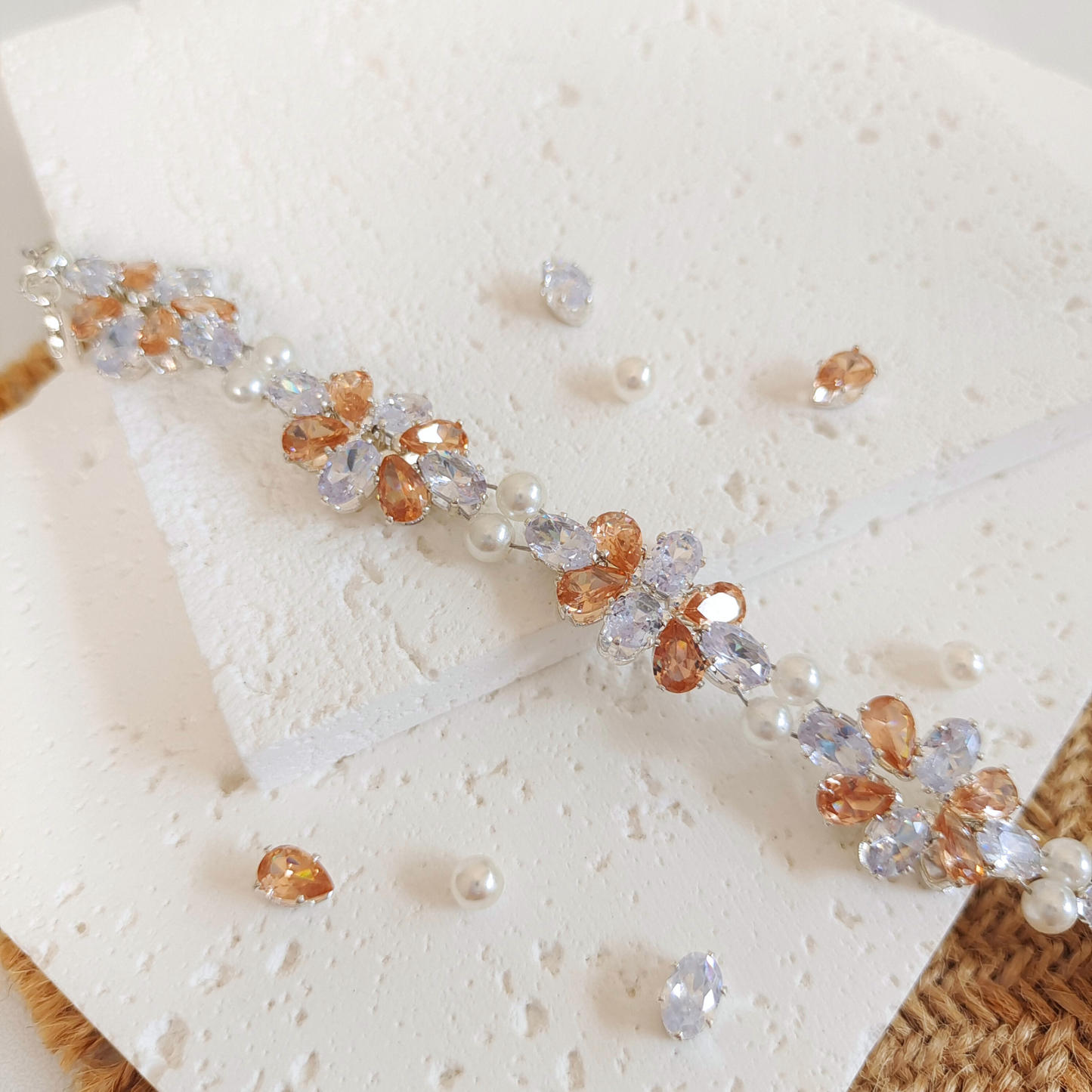 Close-up of white oval and amber teardrop zircon handmade bracelet