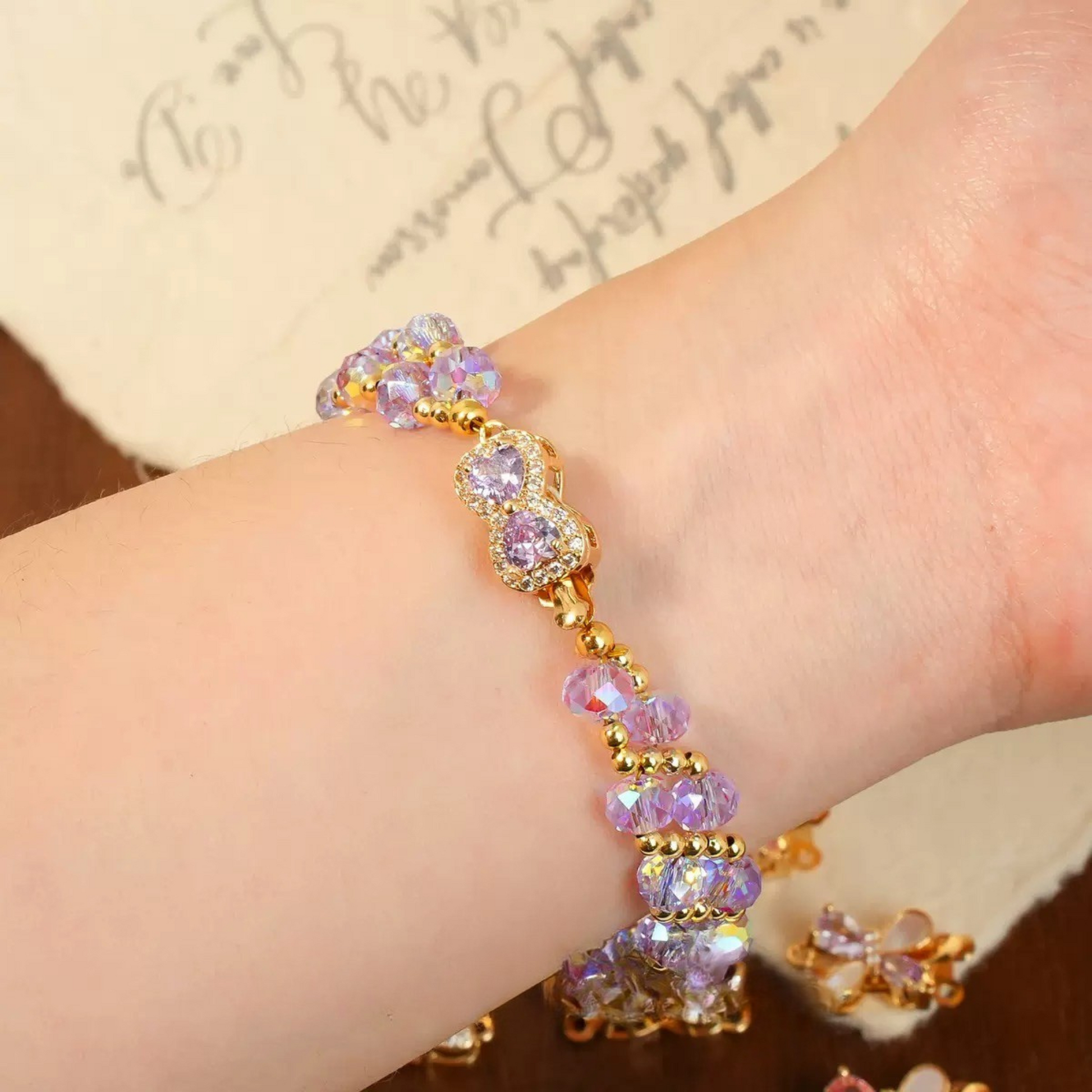 Purple disc spacer bead bracelet worn on wrist