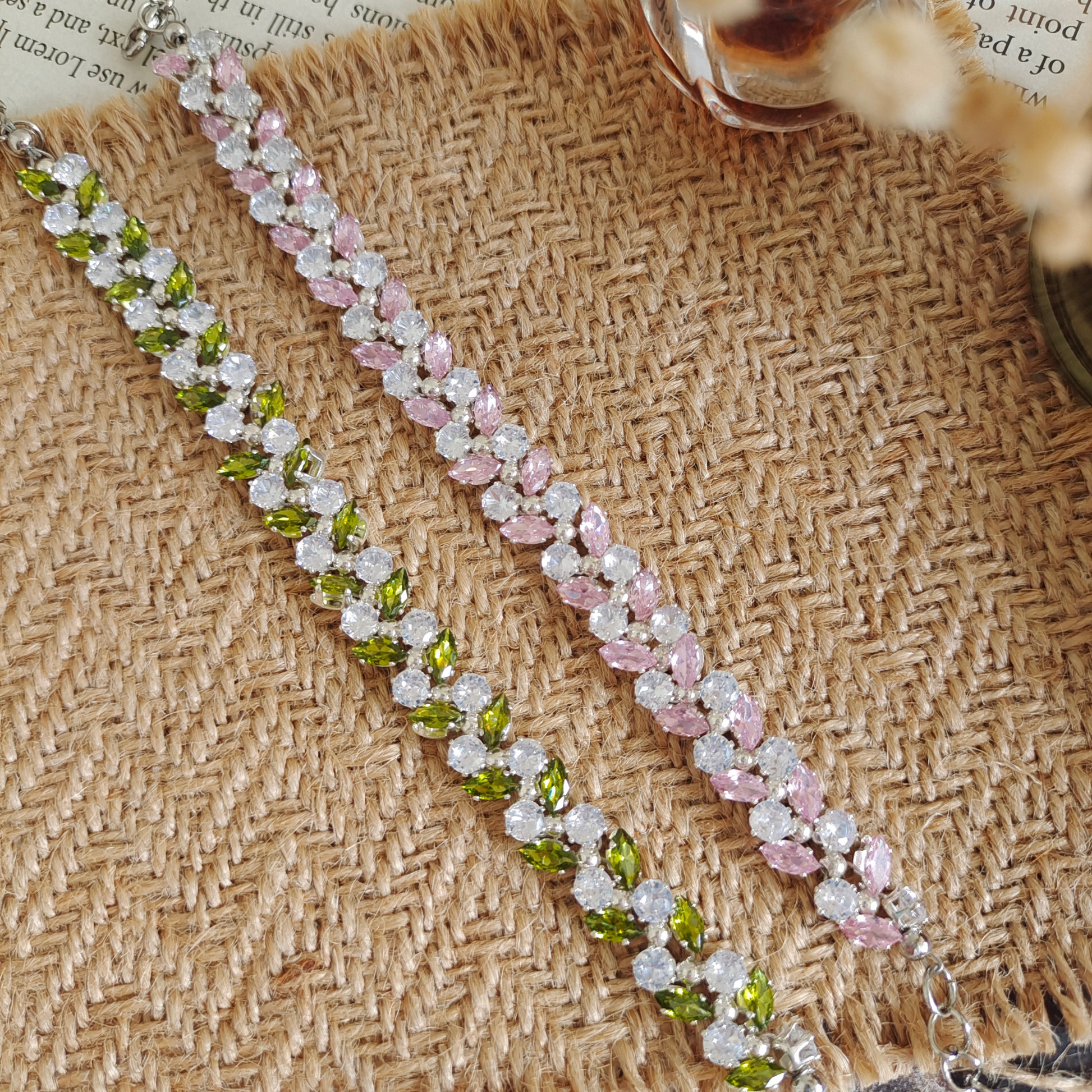 Handcrafted bracelet featuring olive motif and crystal details, flat lay