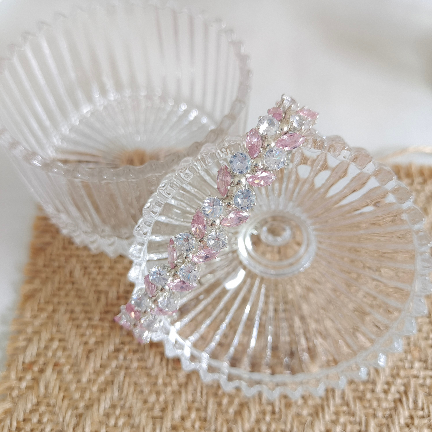 Laid-out view of symbolic olive branch bracelet with CZ accents