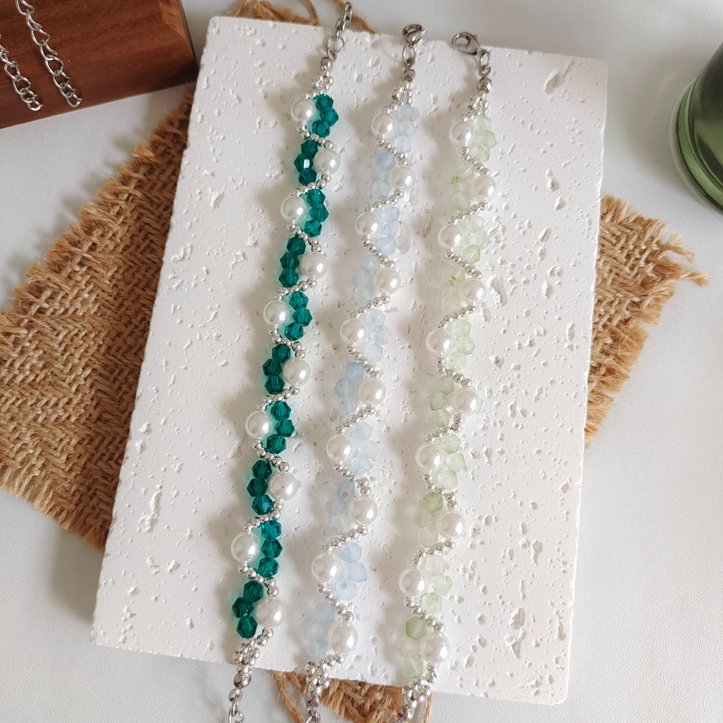 Laid-out view of handmade bracelet with matte crystal beads and large pearls