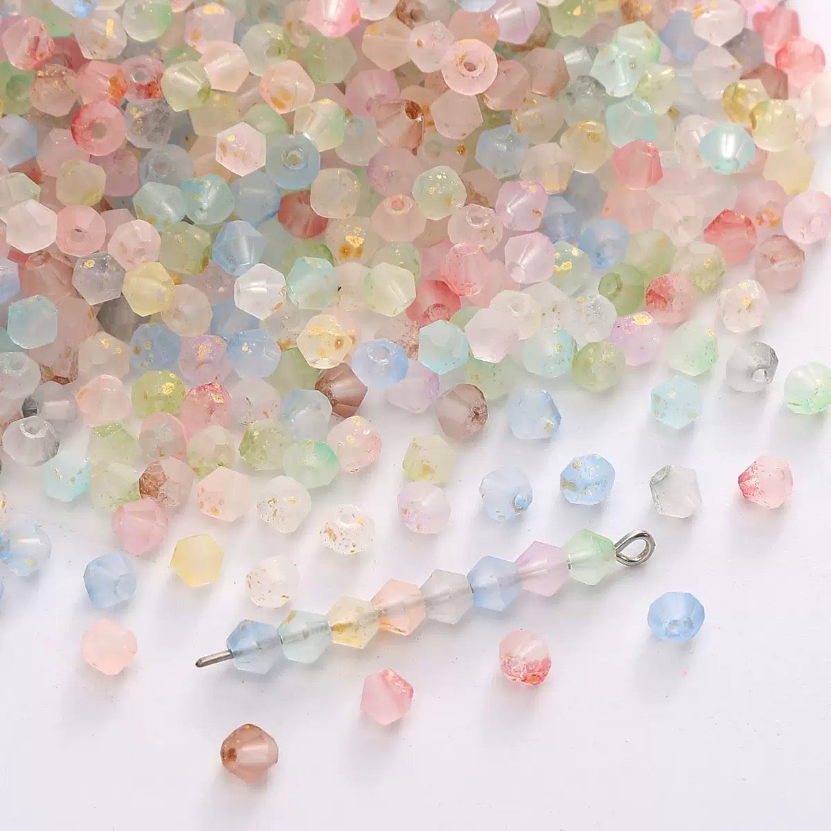 Close-up of matte cream crystal beads with faceted diamond cut