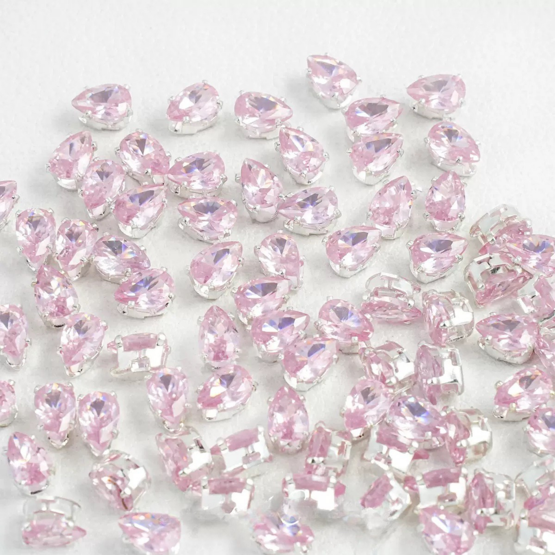 Pink teardrop-shaped zircon spacer bead in silver finish