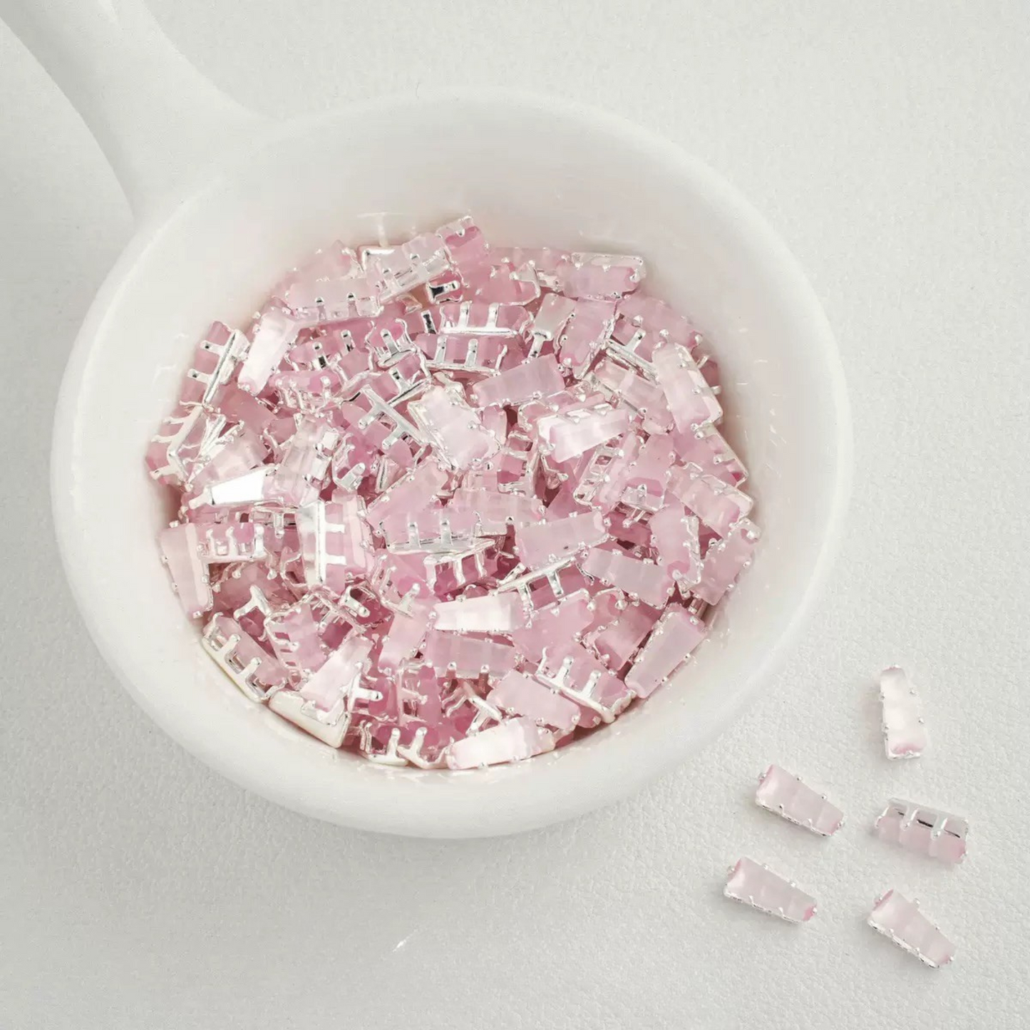Cat eye pink trapezoid-shaped zircon spacer with silver backing