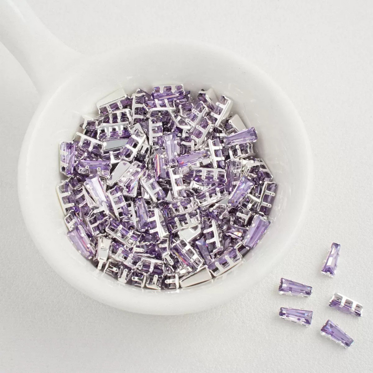 Purple trapezoid-shaped zircon spacer with silver backing