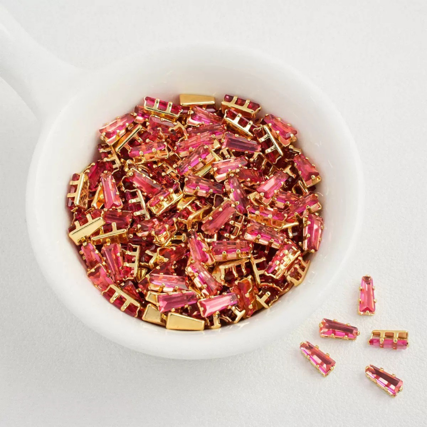 Rose pink trapezoid-shaped zircon spacer with gold backing