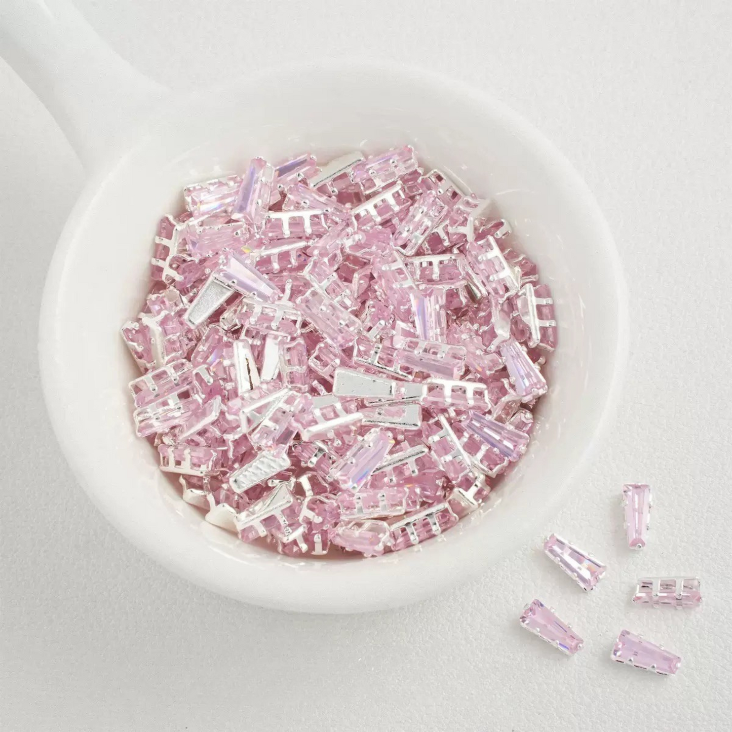 Pink trapezoid-shaped zircon spacer with silver backing