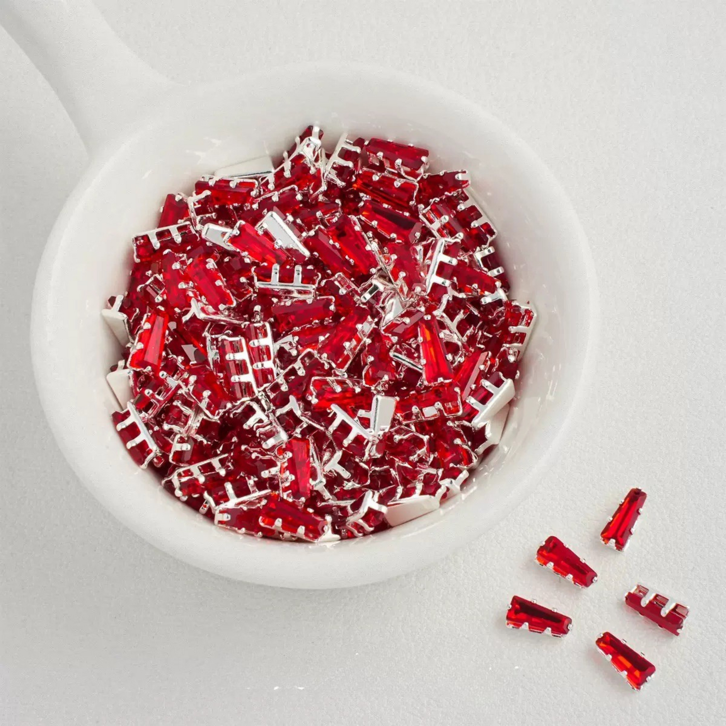 Red trapezoid-shaped zircon spacer with silver backing