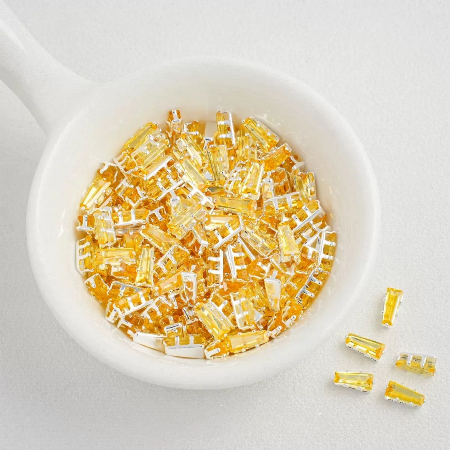 Yellow trapezoid-shaped zircon spacer with silver backing