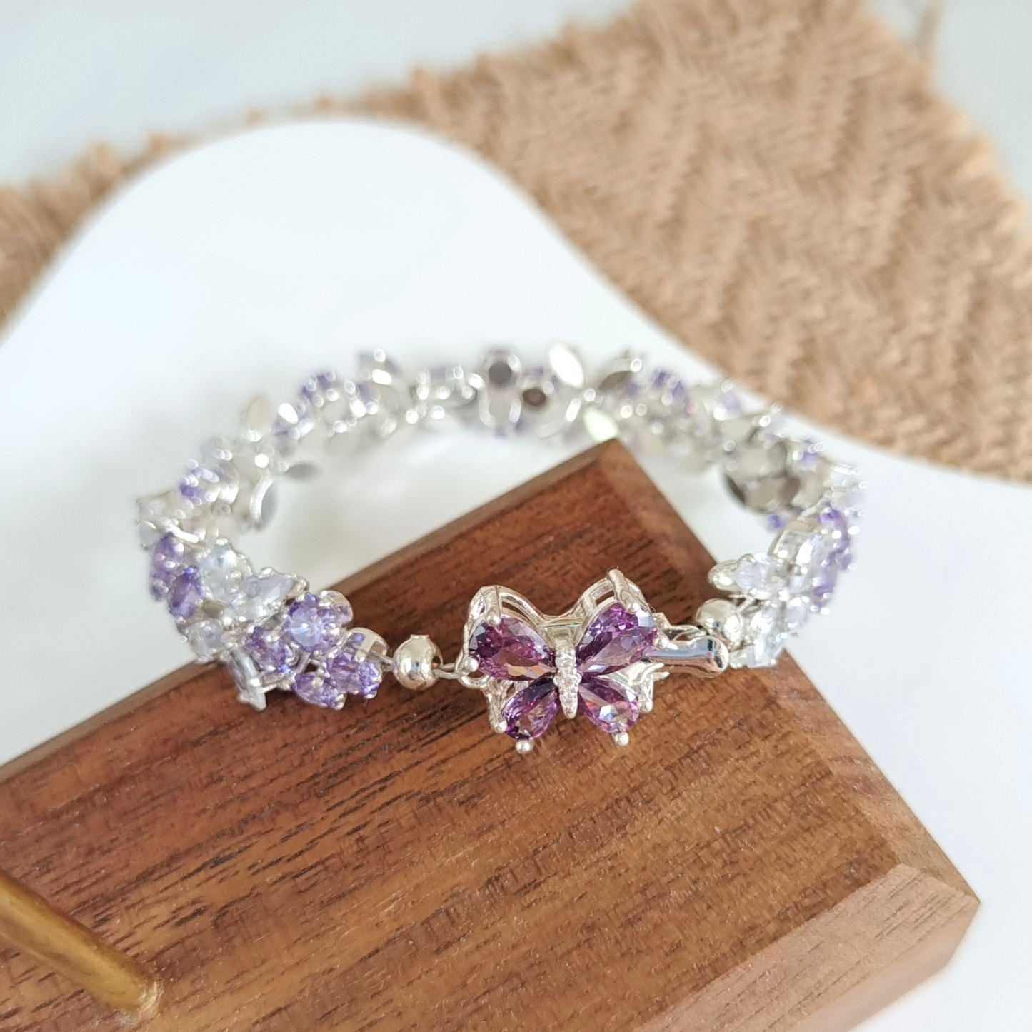 Close-up of purple zircon butterfly charm with marquise crystal wings.