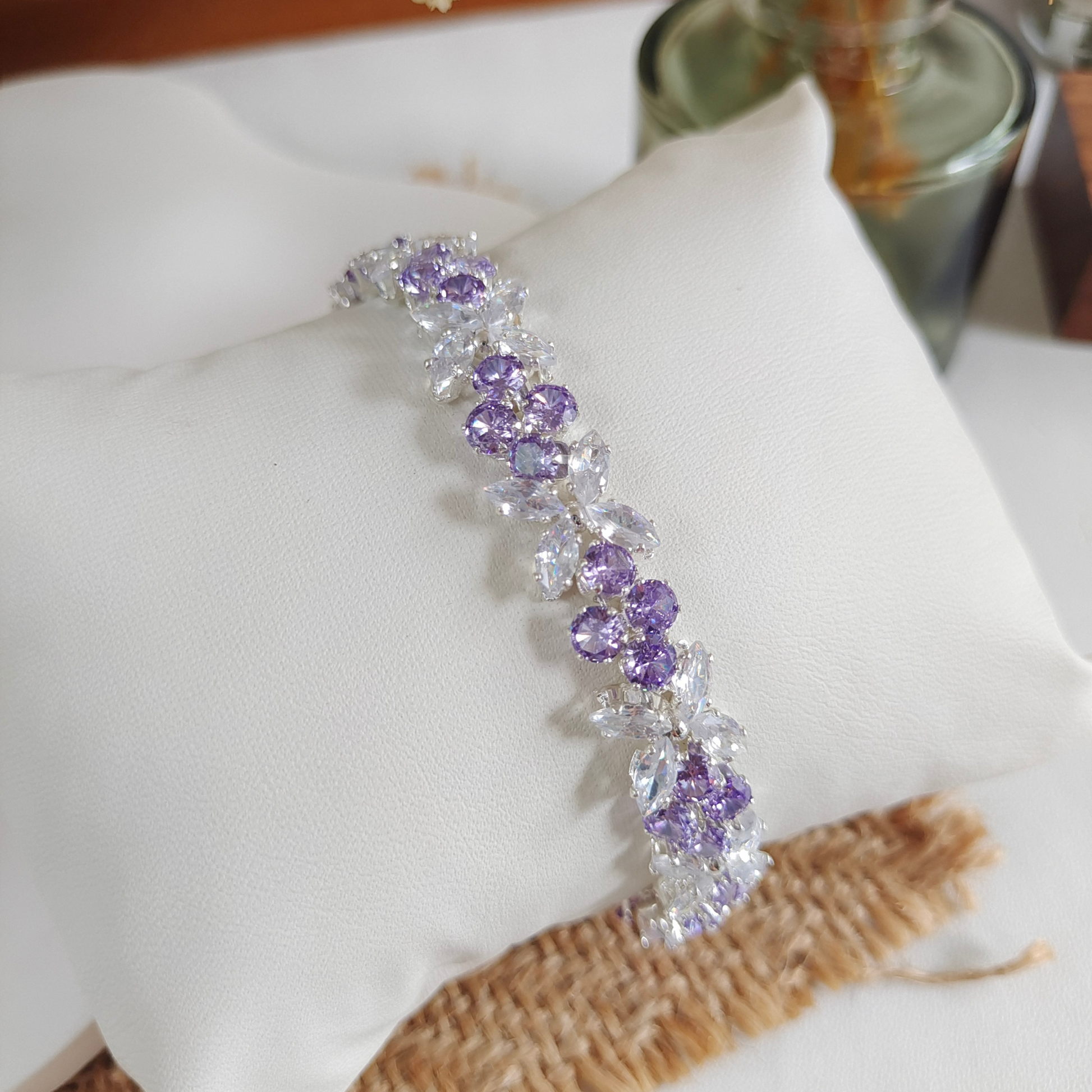 Detailed shot of violet round stones and shimmering navette-cut zircons.