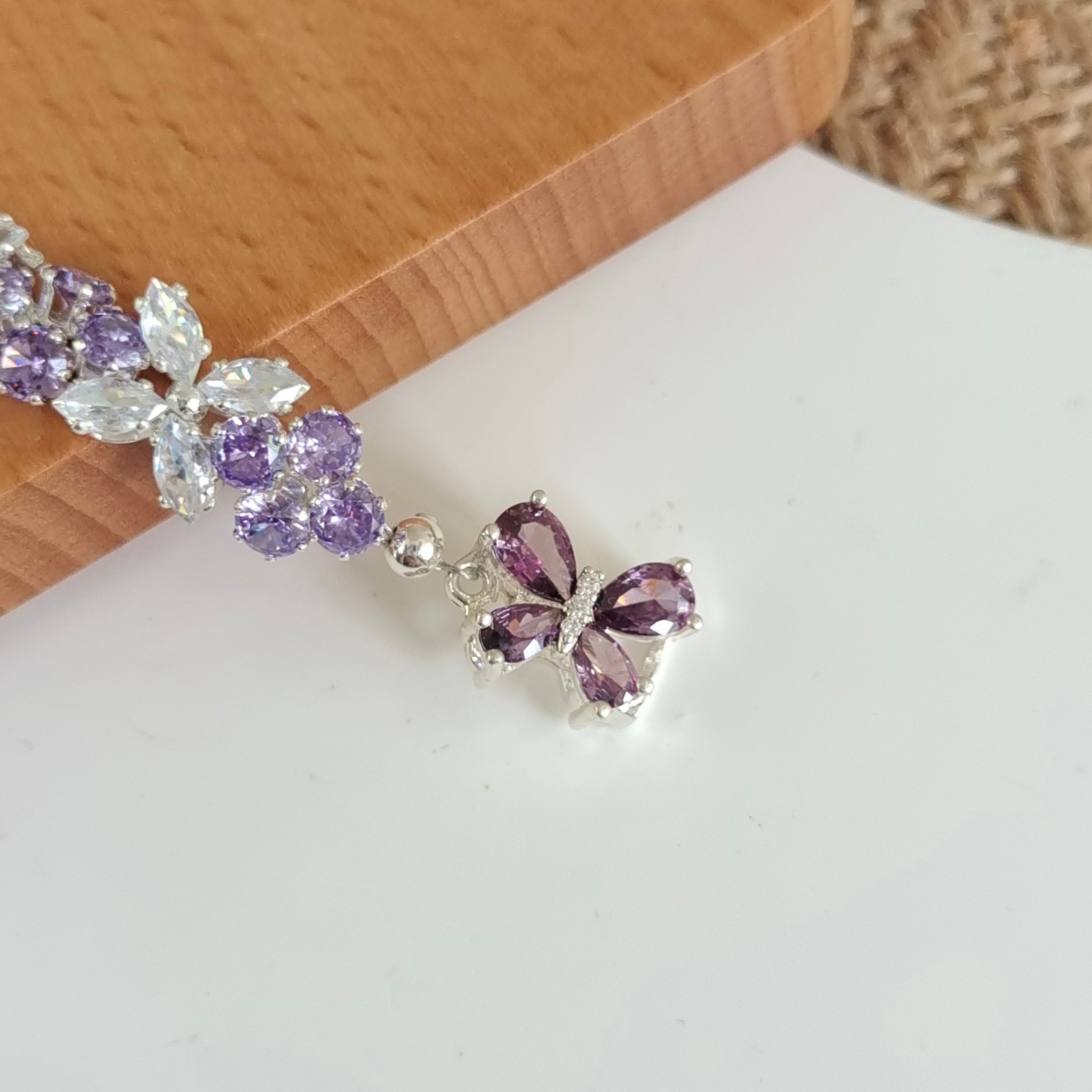 Fine details of purple gemstone bracelet featuring multi-cut zircon accents.