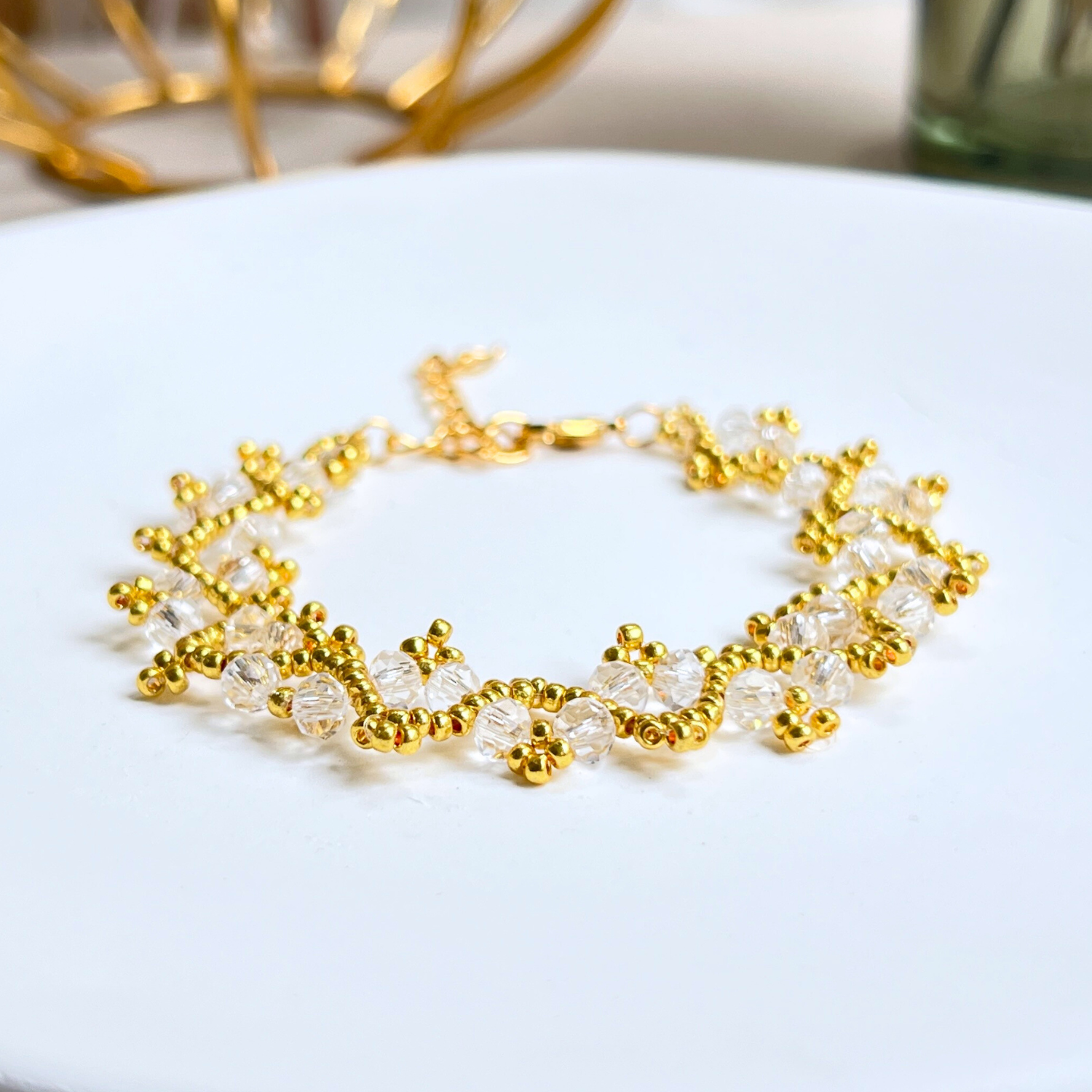 Detail shot of a handmade bracelet with clear wheel-shaped beads