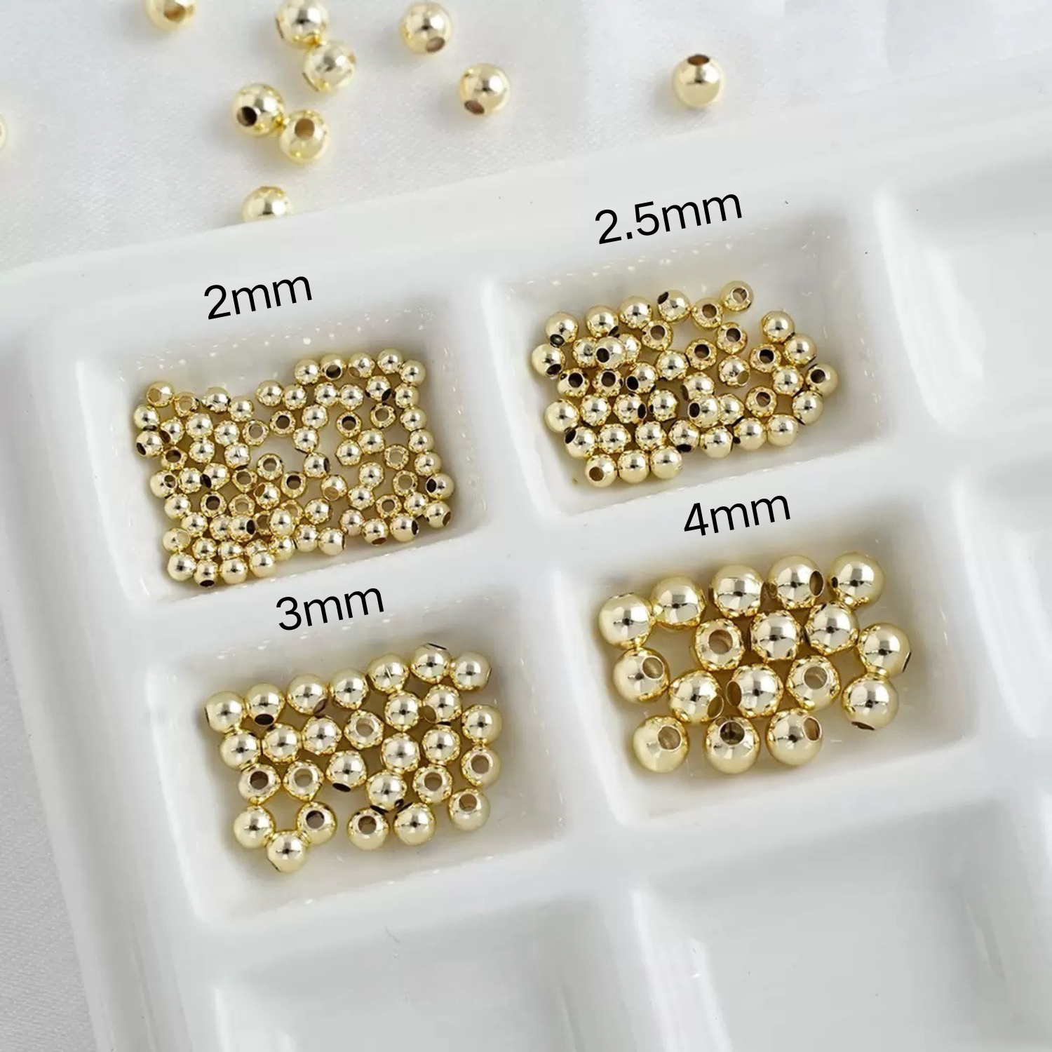 Assorted gold seed beads ranging from small to large sizes
