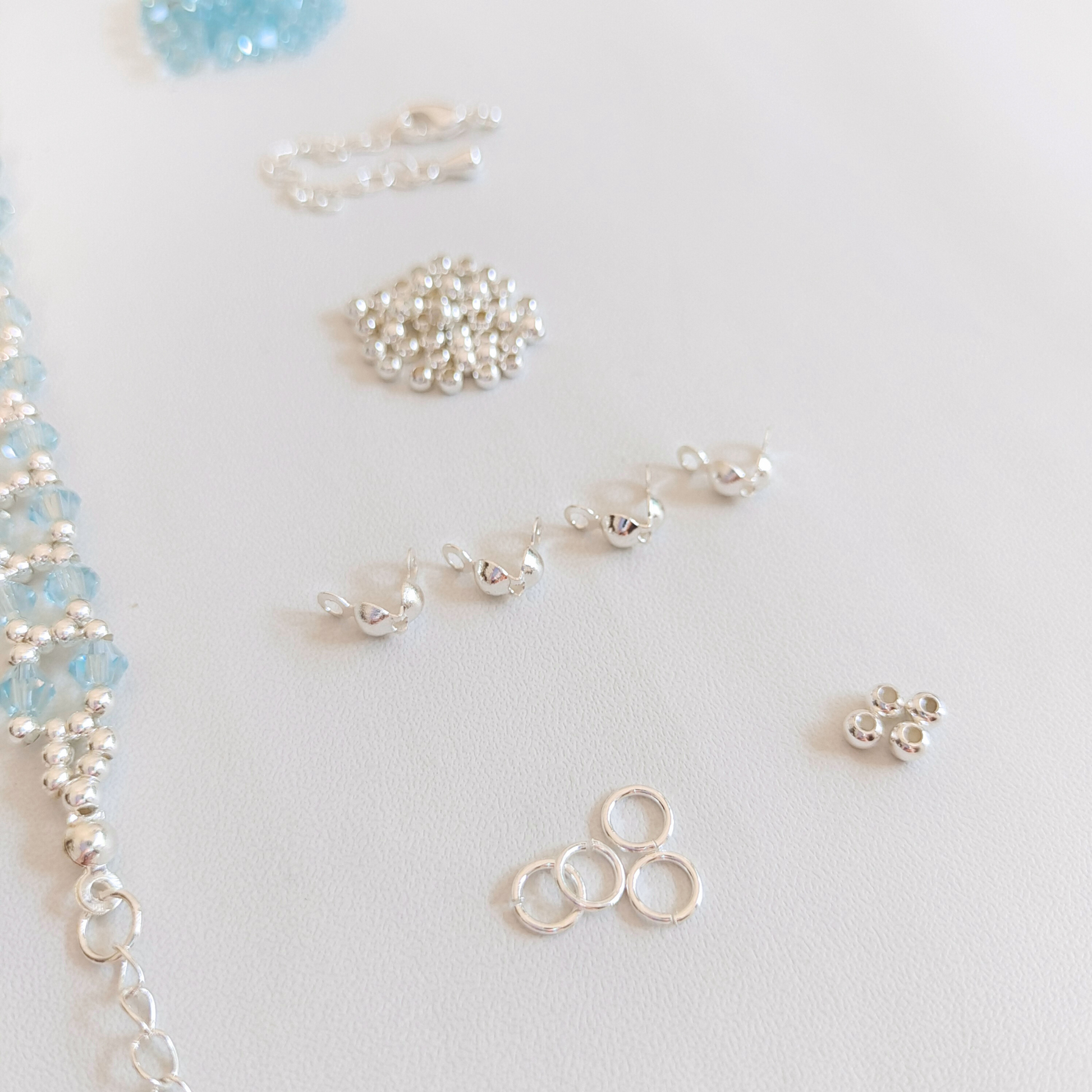 Jewelry kit: icy lake blue crystals, silver seed beads, and findings