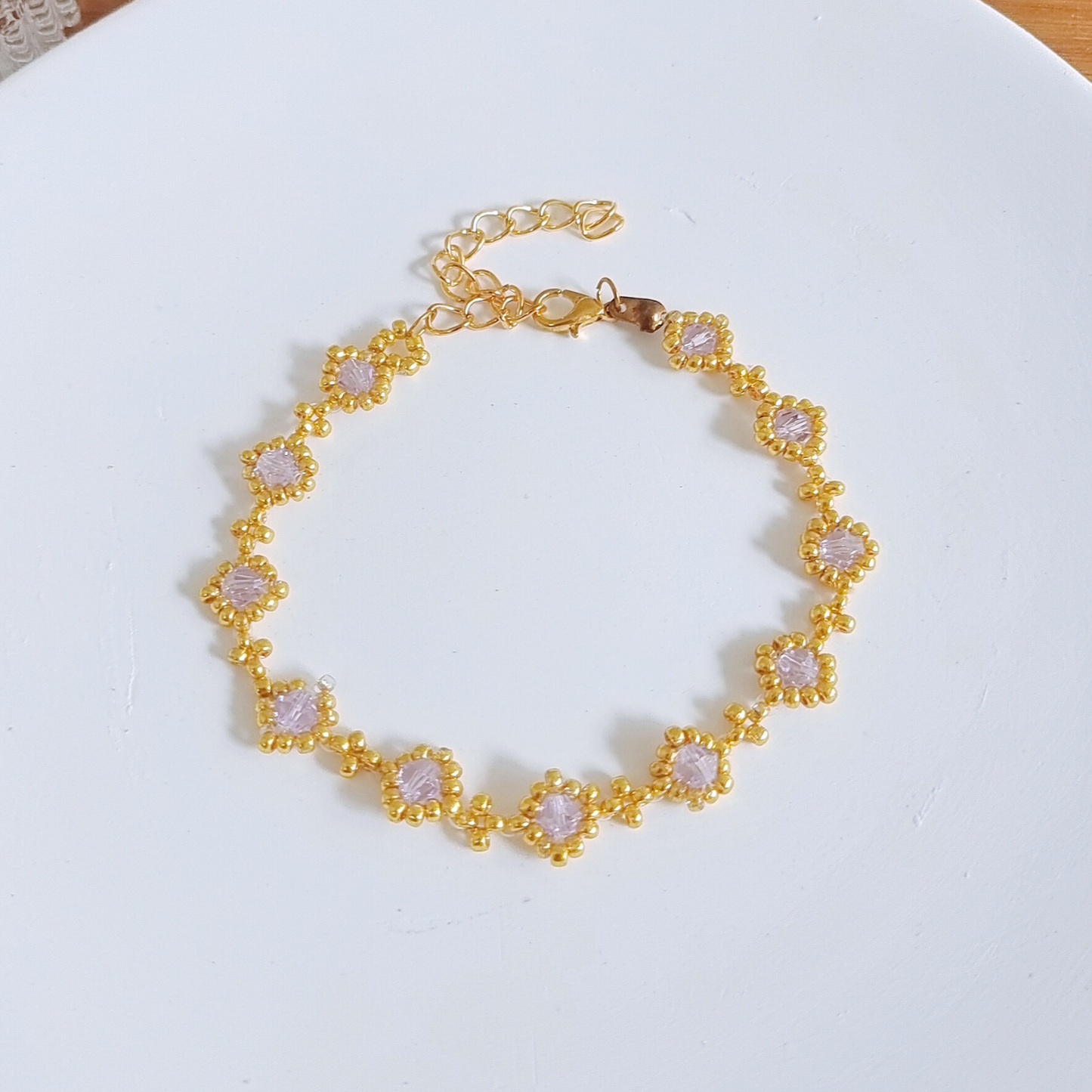 Full view of a handmade beaded bracelet with light purple beads