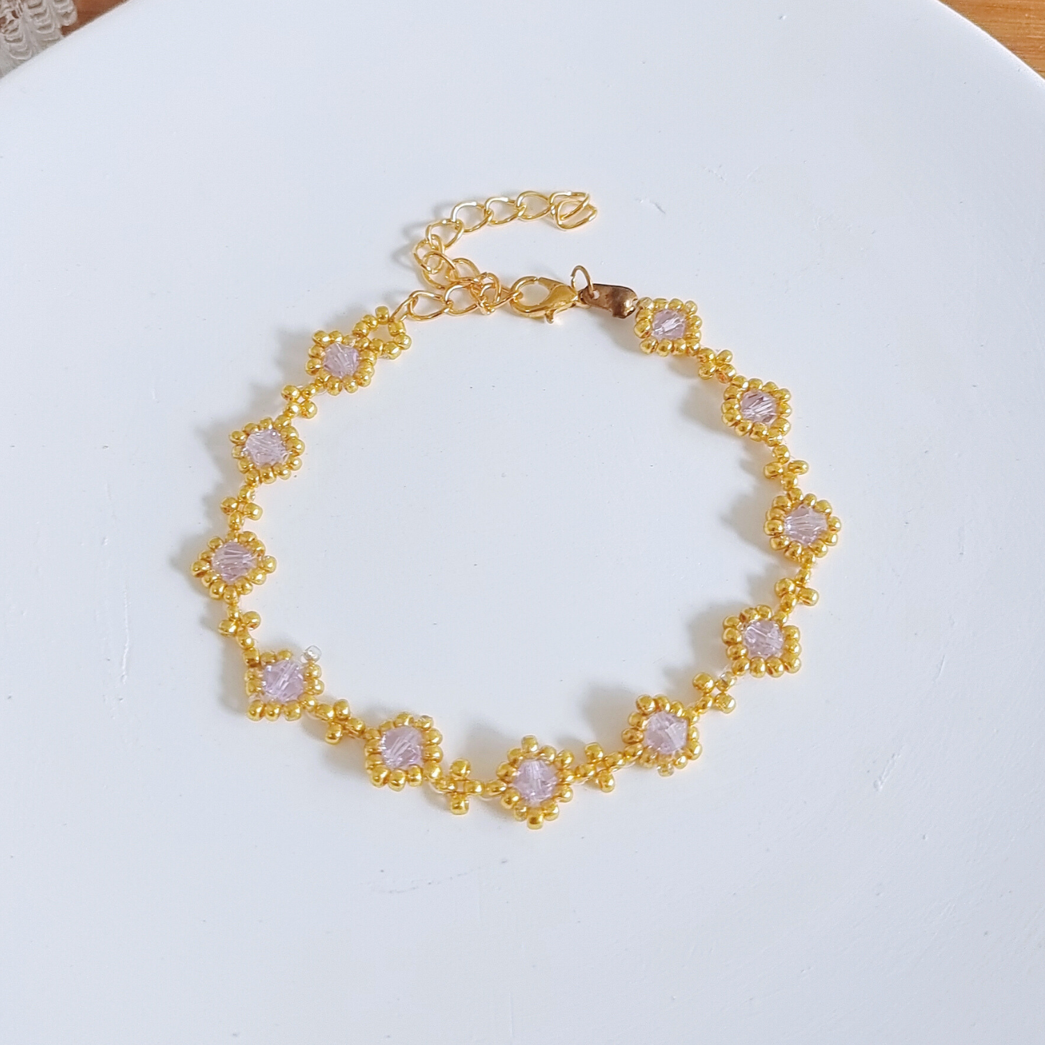 Full view of a handmade beaded bracelet with light purple beads