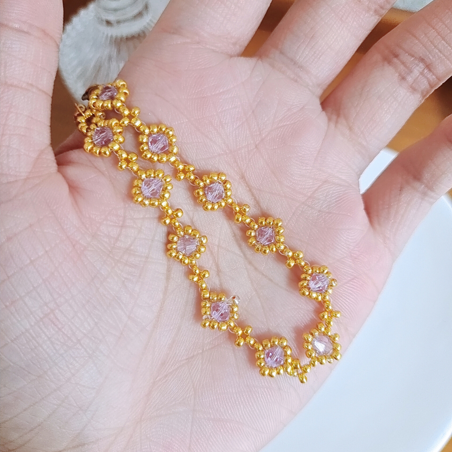 Handmade light purple bracelet displayed in palm