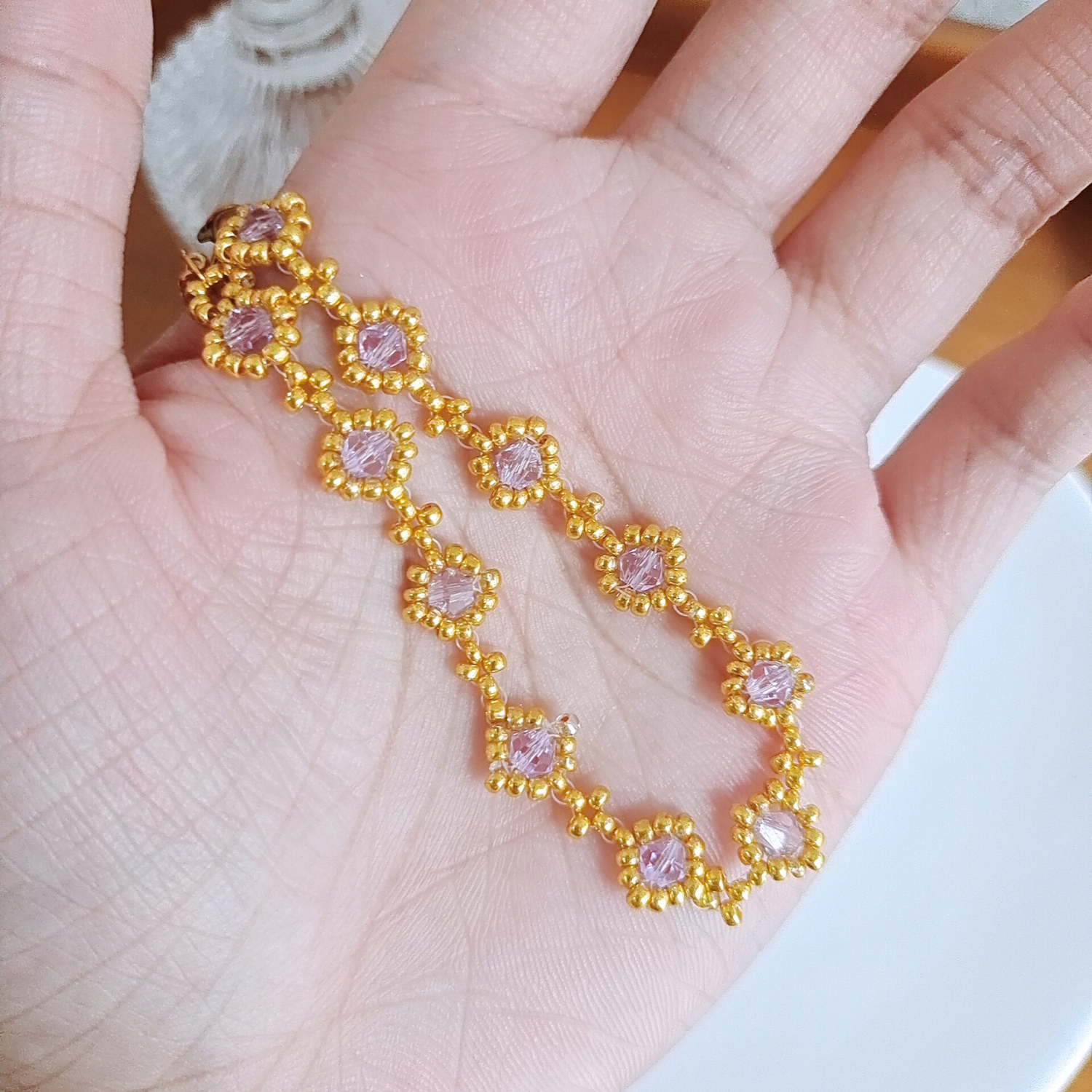 Handmade light purple bracelet displayed in palm