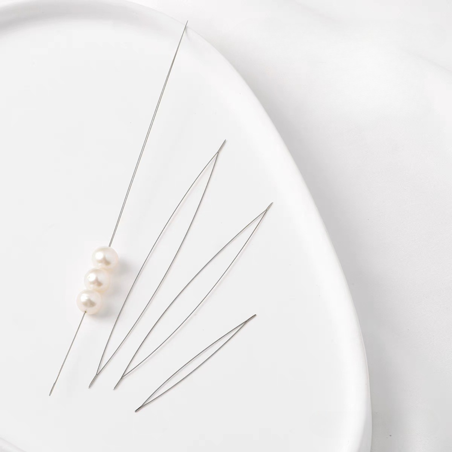 Three beading needle sizes displayed