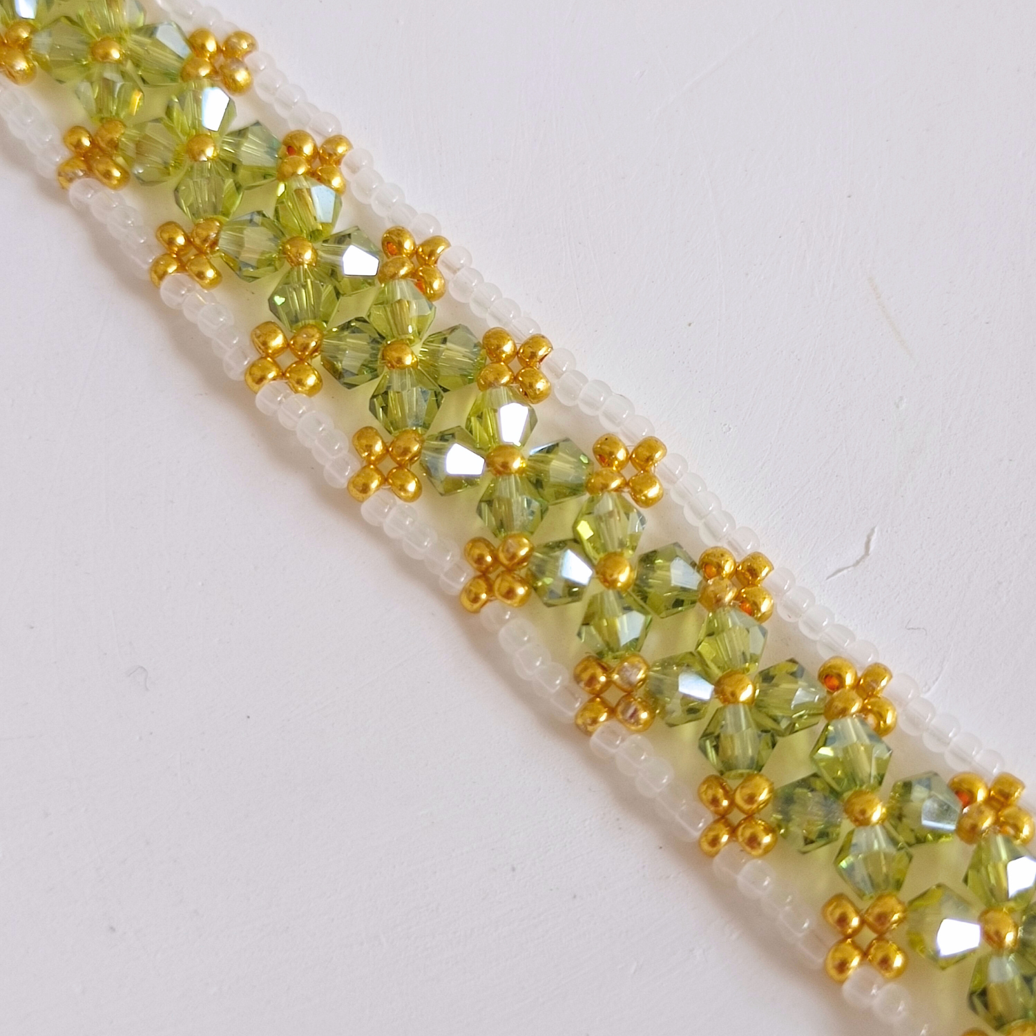 Close-up detail of olive green beaded bracelet