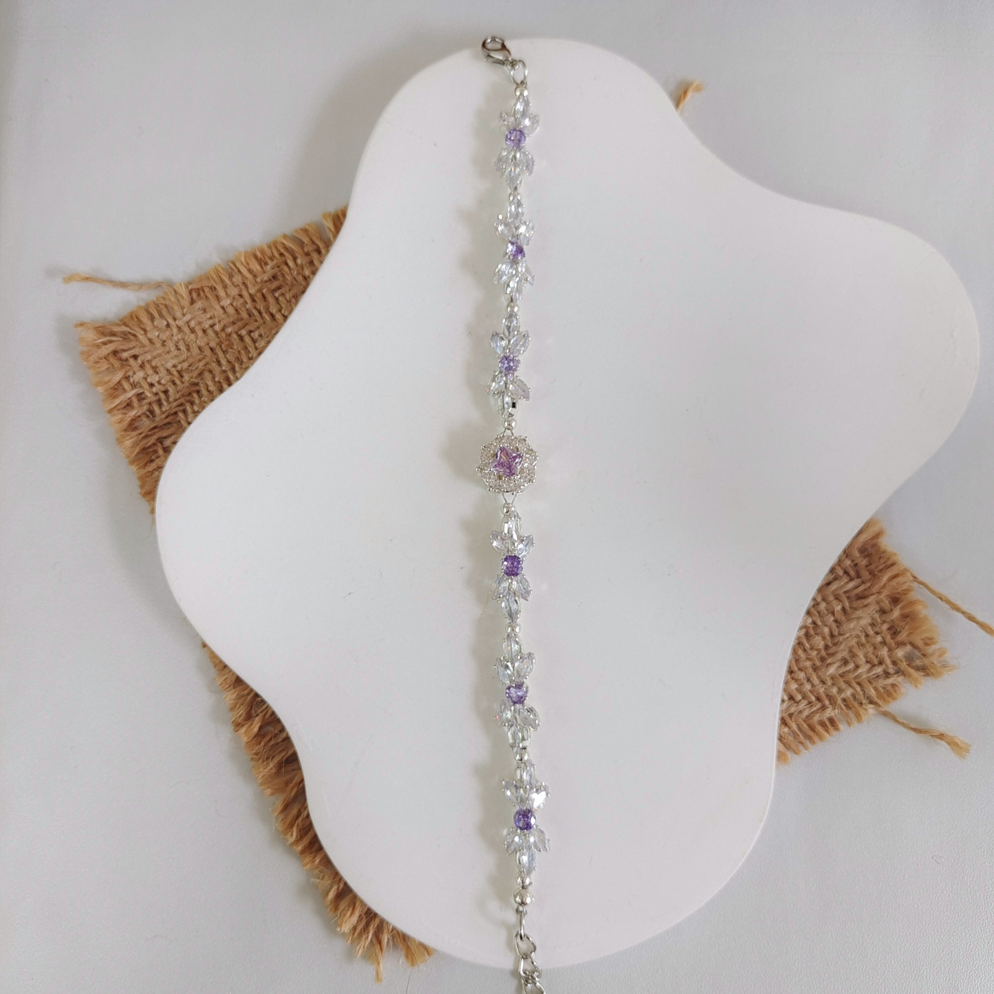 Crystal bow bracelet with clear marquise CZ and large purple zircon spacer bead