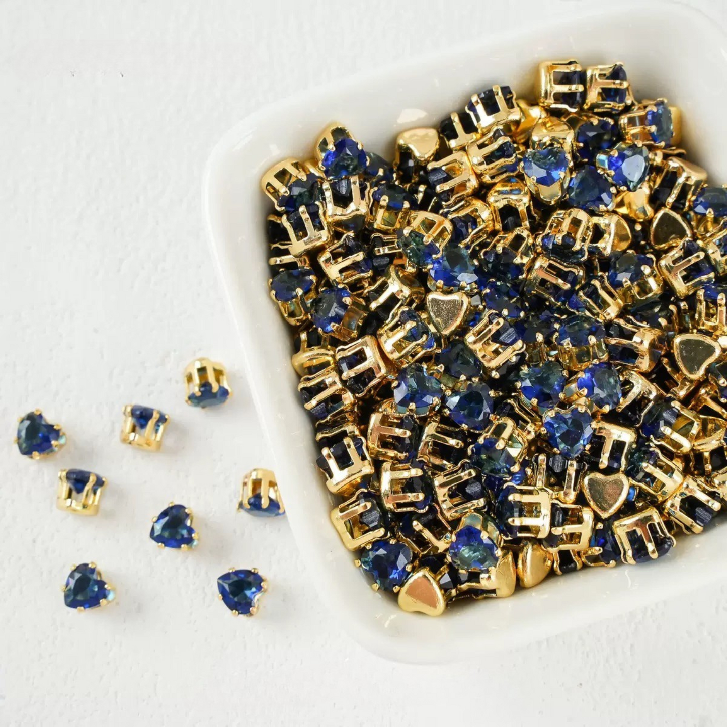 Dark blue heart-shaped cubic zirconia in gold-plated claw setting