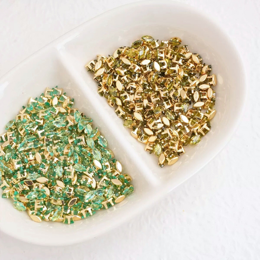 Marquise-cut cubic zirconia stones in gold-plated claw settings