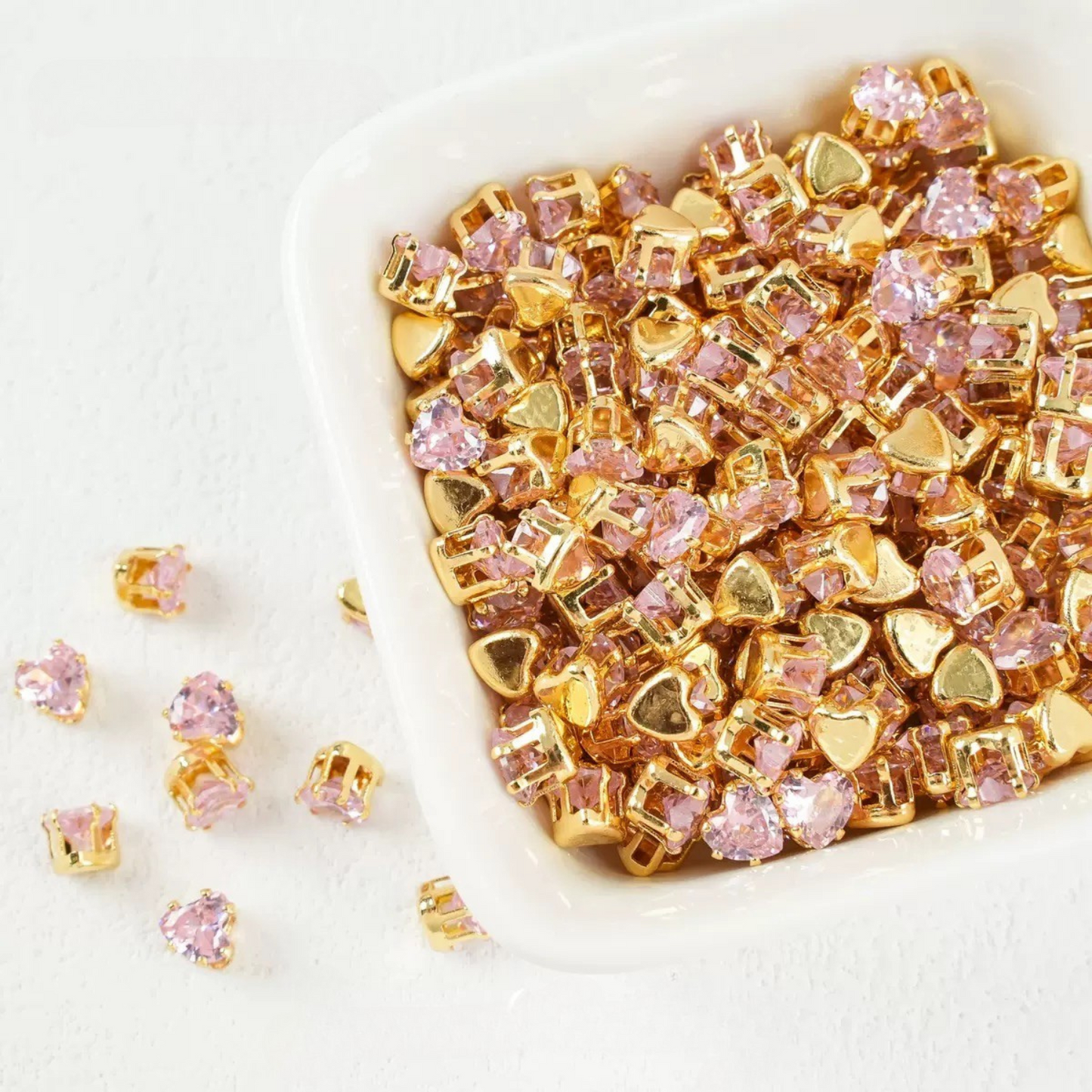 Pink heart-shaped cubic zirconia in gold-plated claw setting