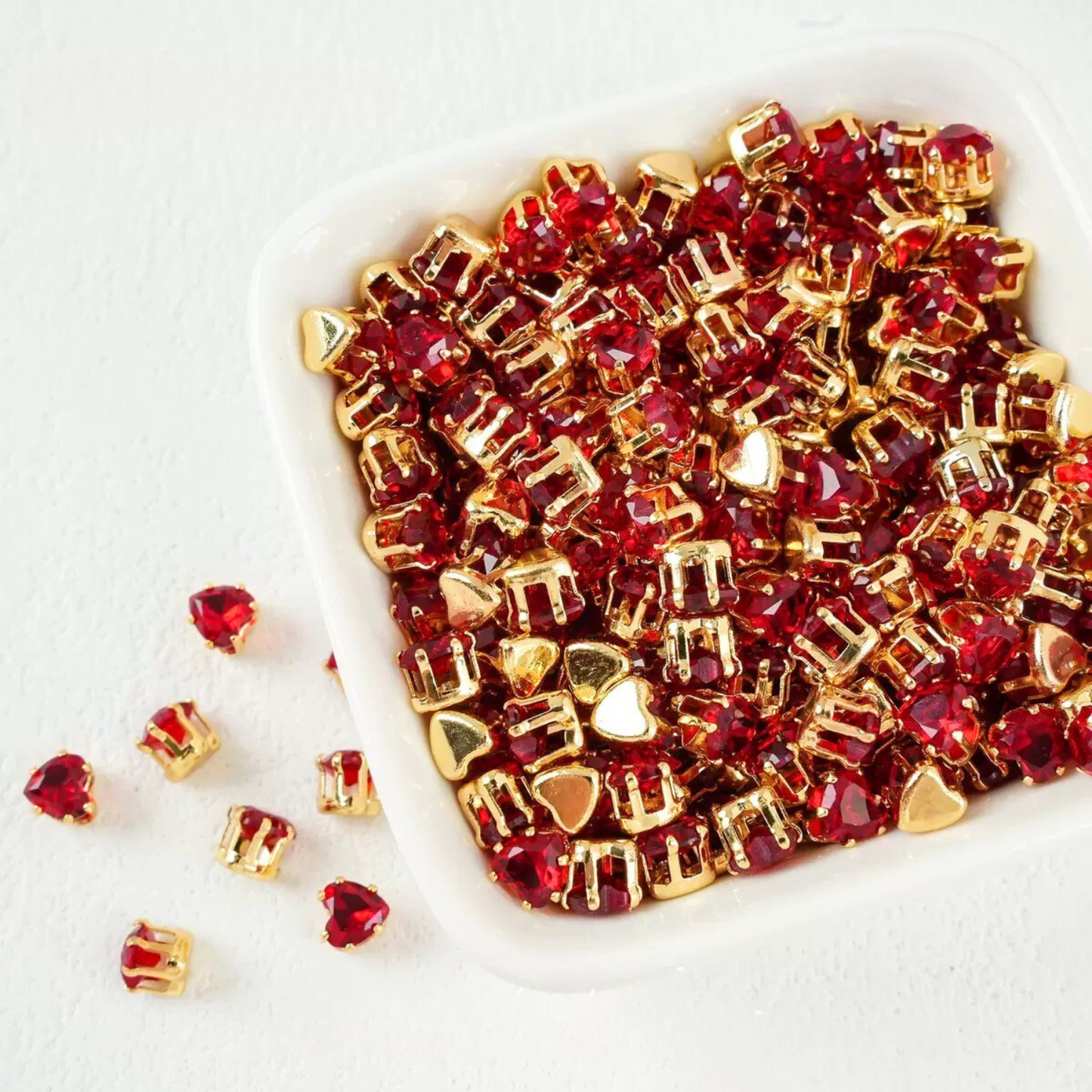 Red heart-shaped cubic zirconia in gold-plated claw setting