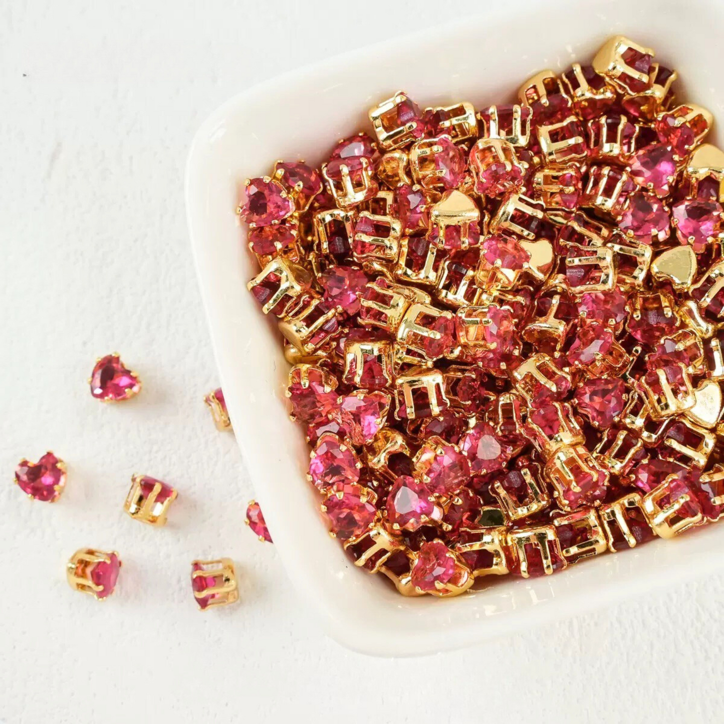 Rose pink heart-shaped cubic zirconia in gold-plated claw setting