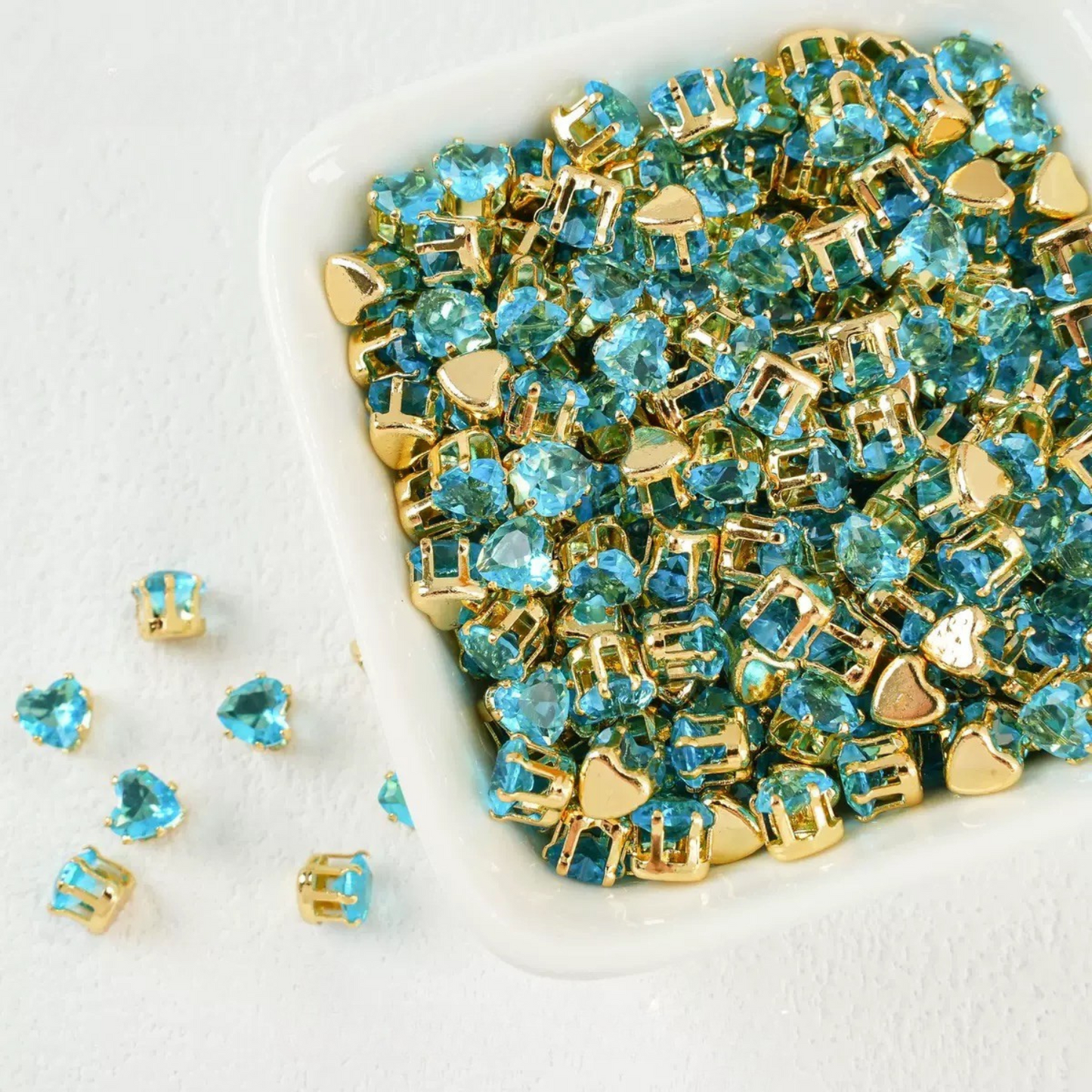 Sky blue heart-shaped cubic zirconia in gold-plated claw setting