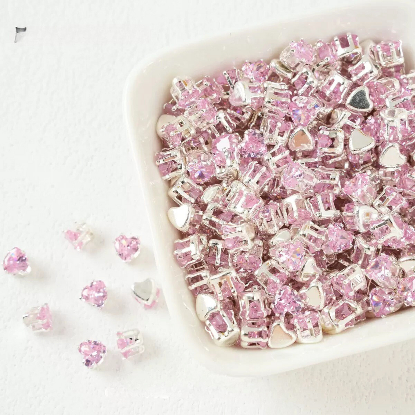 Pink heart-shaped cubic zirconia with silver-plated claw setting