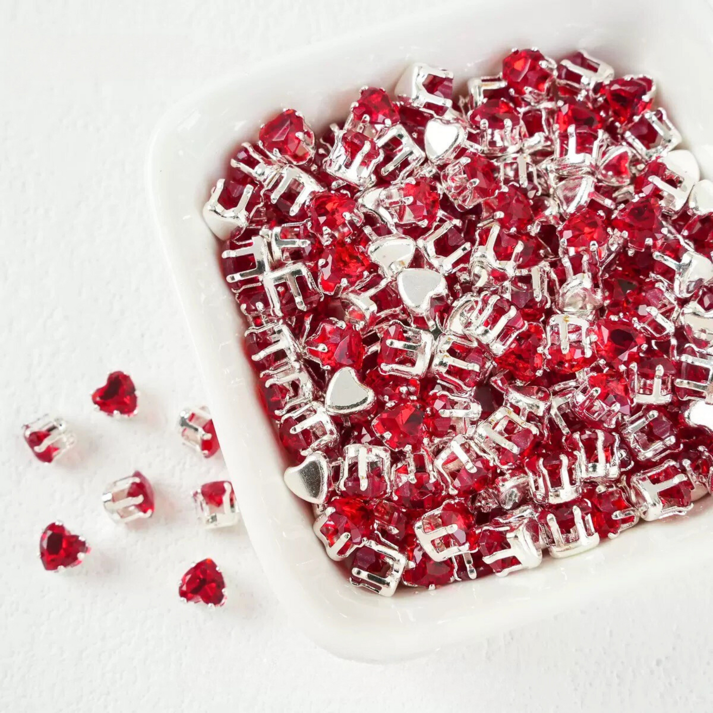Red heart-shaped cubic zirconia with silver-plated claw setting