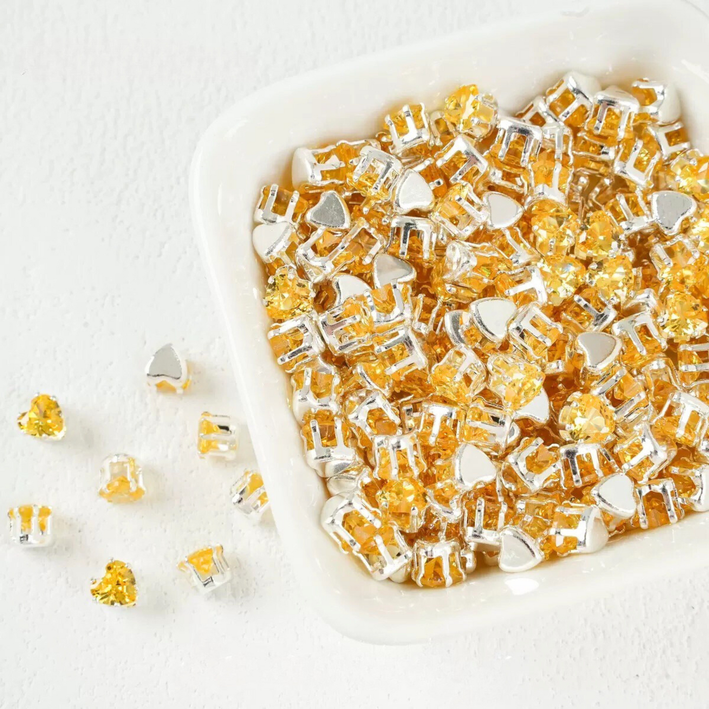 Yellow heart-shaped cubic zirconia with silver-plated claw setting