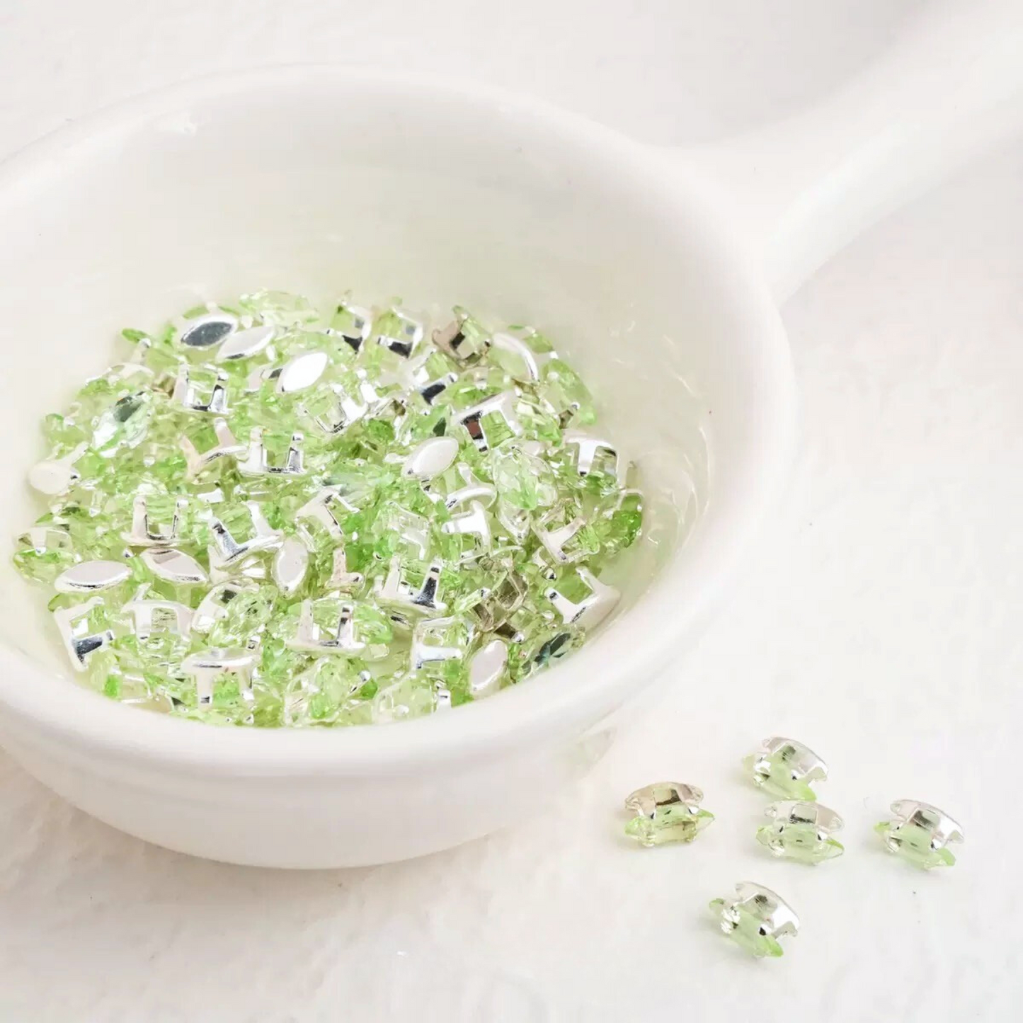 Apple green marquise-cut cubic zirconia in silver-plated claw settings