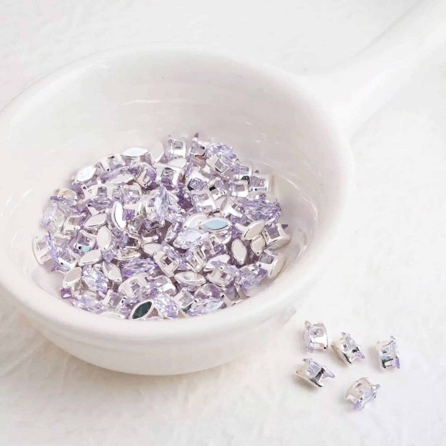 light purple marquise-shaped zirconia crystals with silver-tone claw