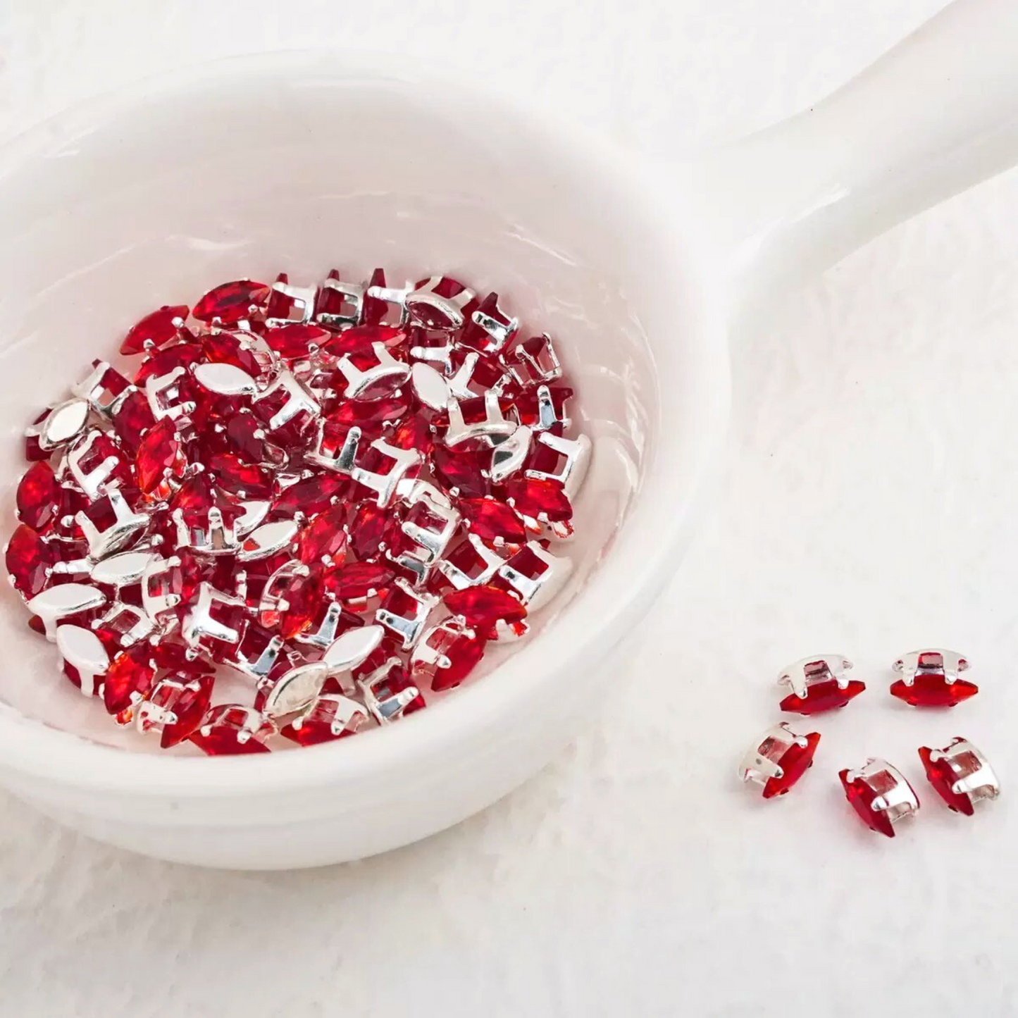 Red faceted marquise CZ gemstones in silver prong settings