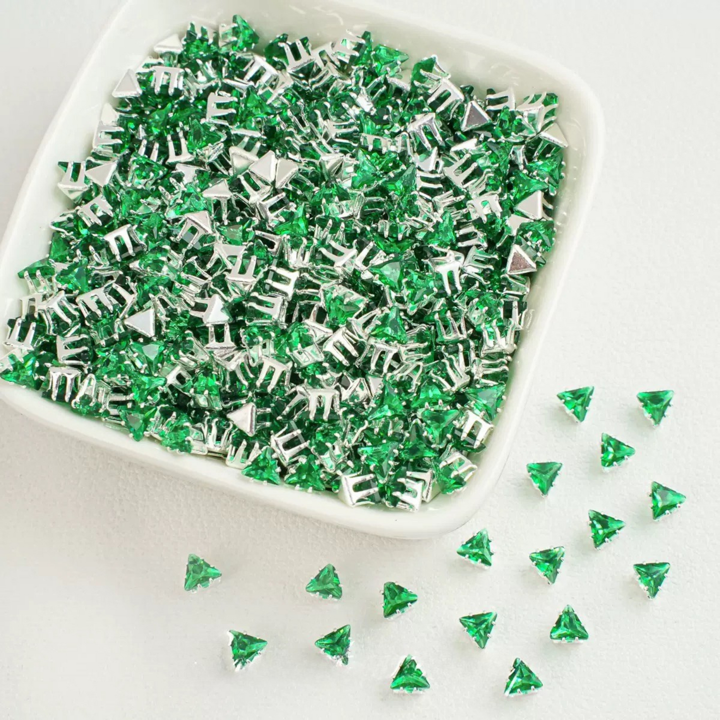 Green faceted triangle zirconia beads set on silver backing