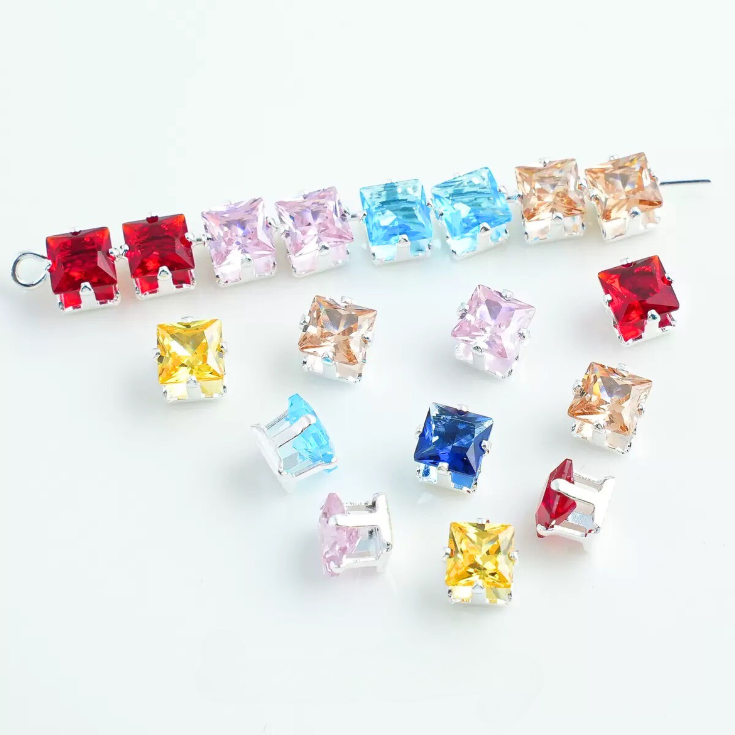 Square-cut cubic zirconia in silver-plated claw settings