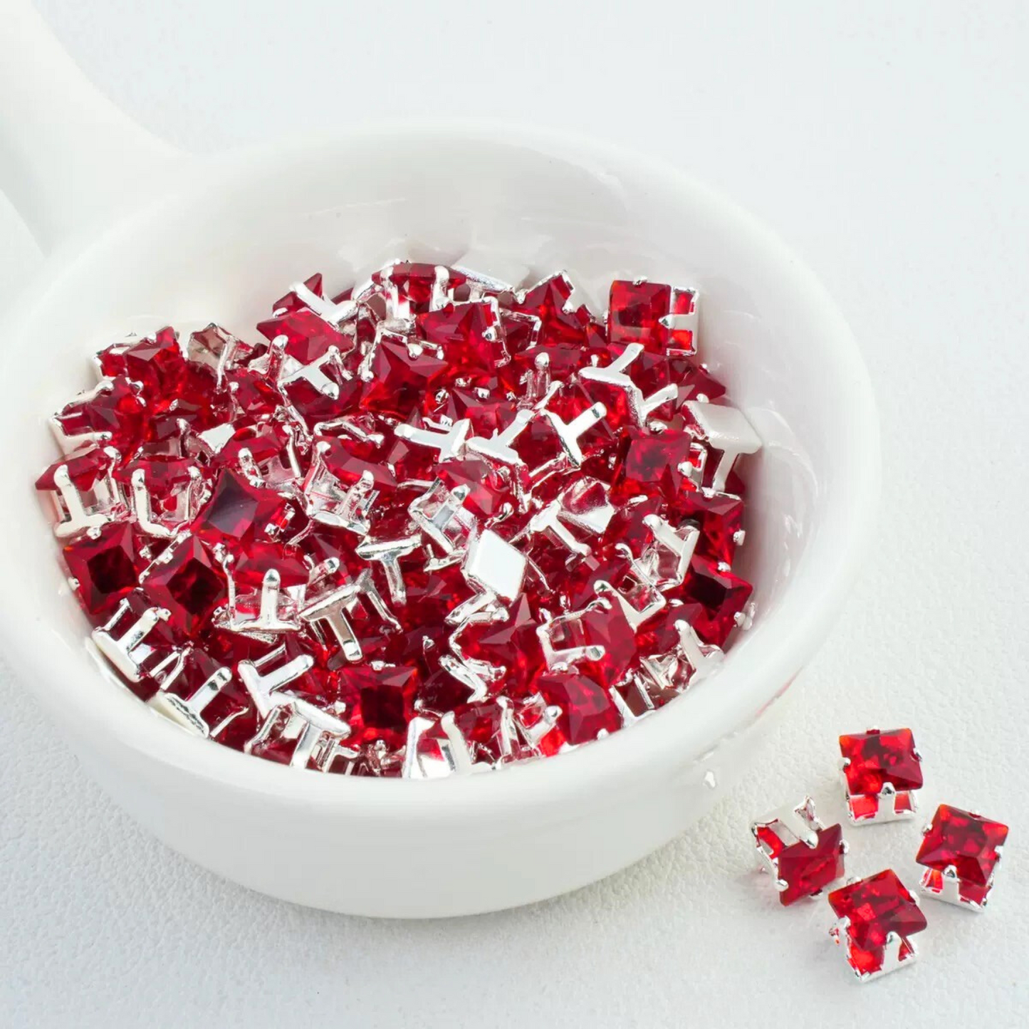 Precision-cut red square CZ in silver-plated prong settings
