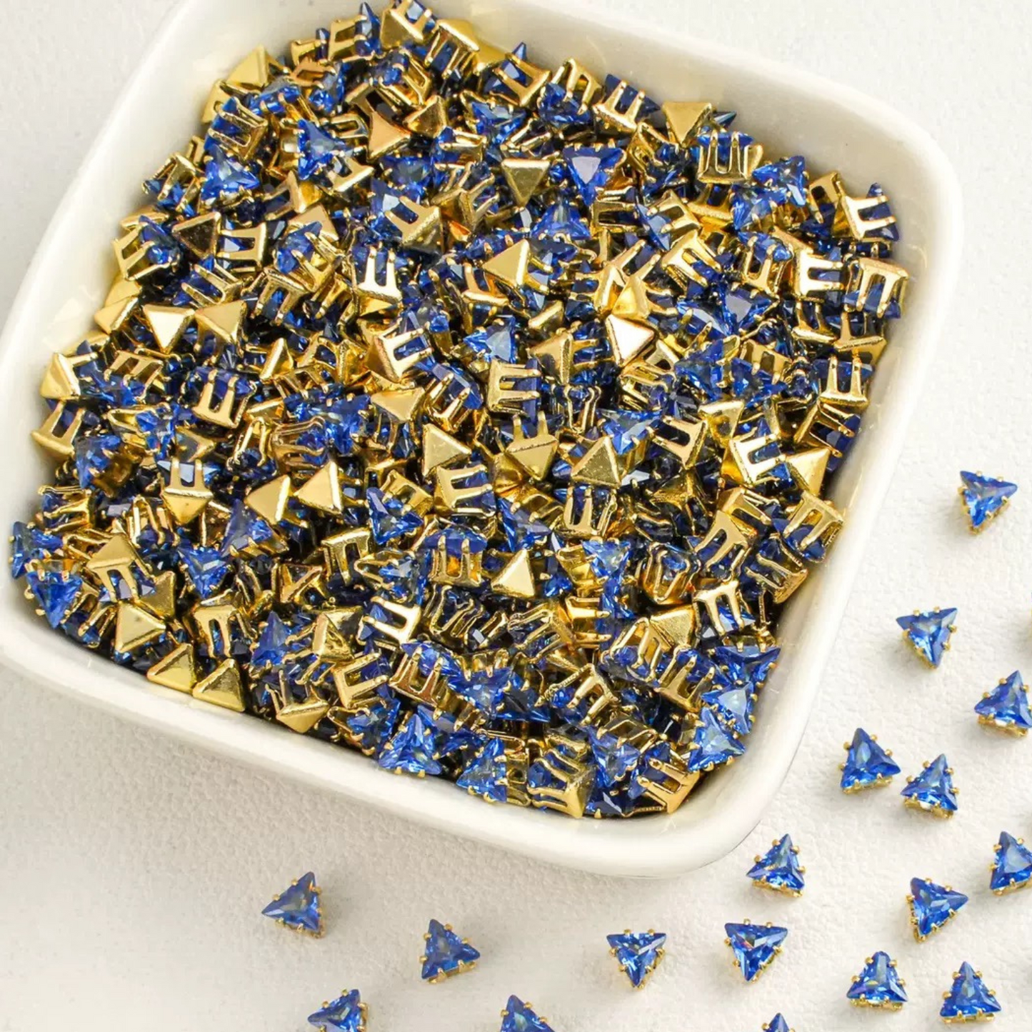 Triangle-shaped dark blue zircon beads with gold base