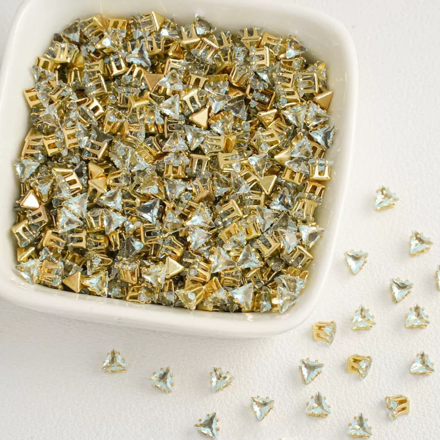 Triangle-shaped ice blue zircon beads with gold base