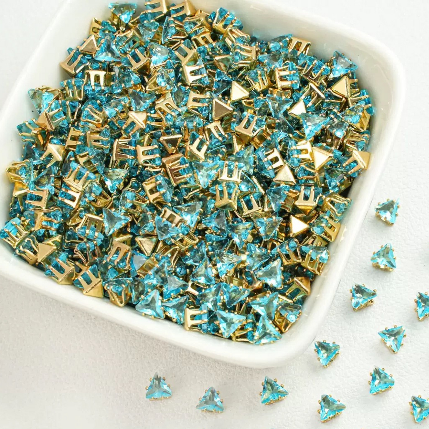 Triangle-shaped lake blue zircon beads with gold base