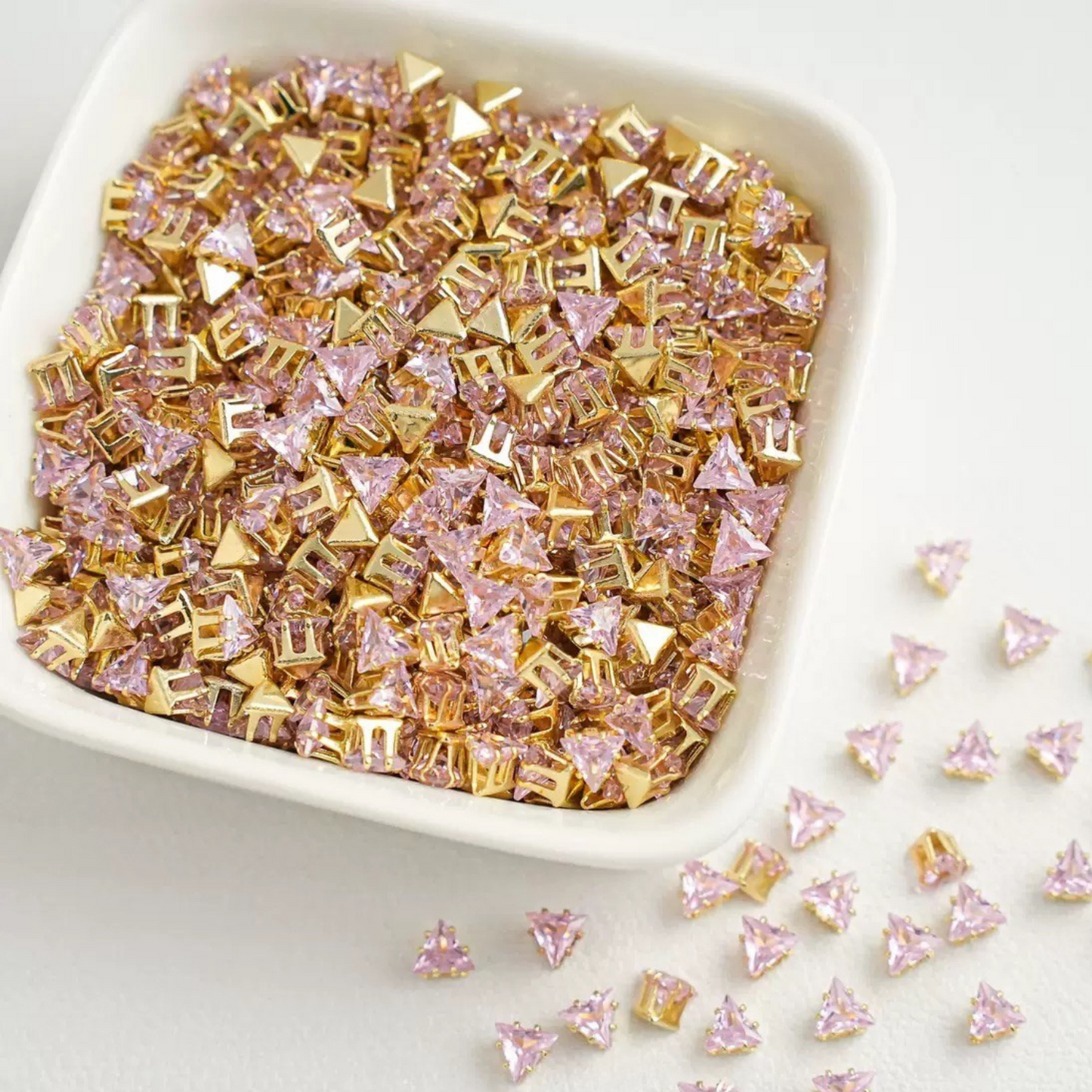 Triangle-shaped pink zircon beads with gold base