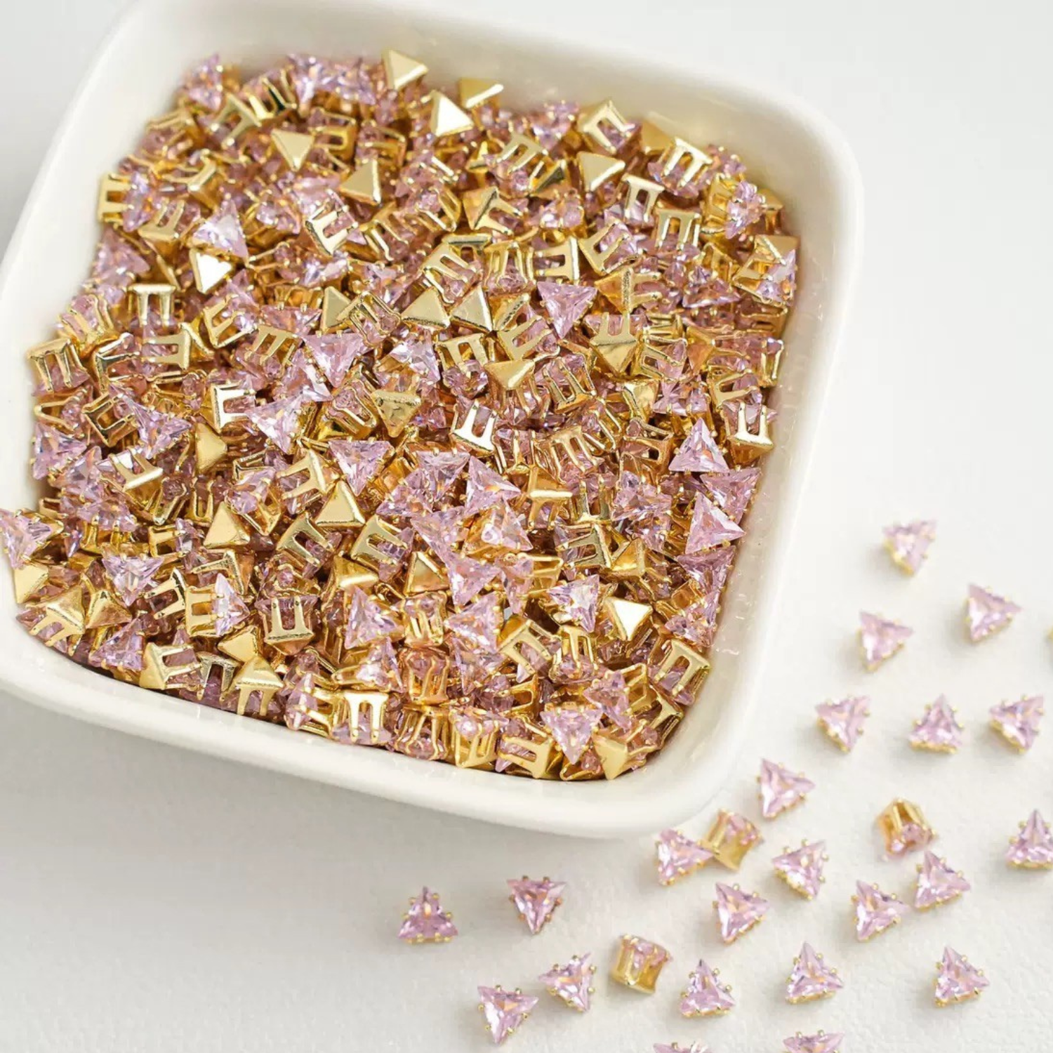Triangle-shaped pink zircon beads with gold base