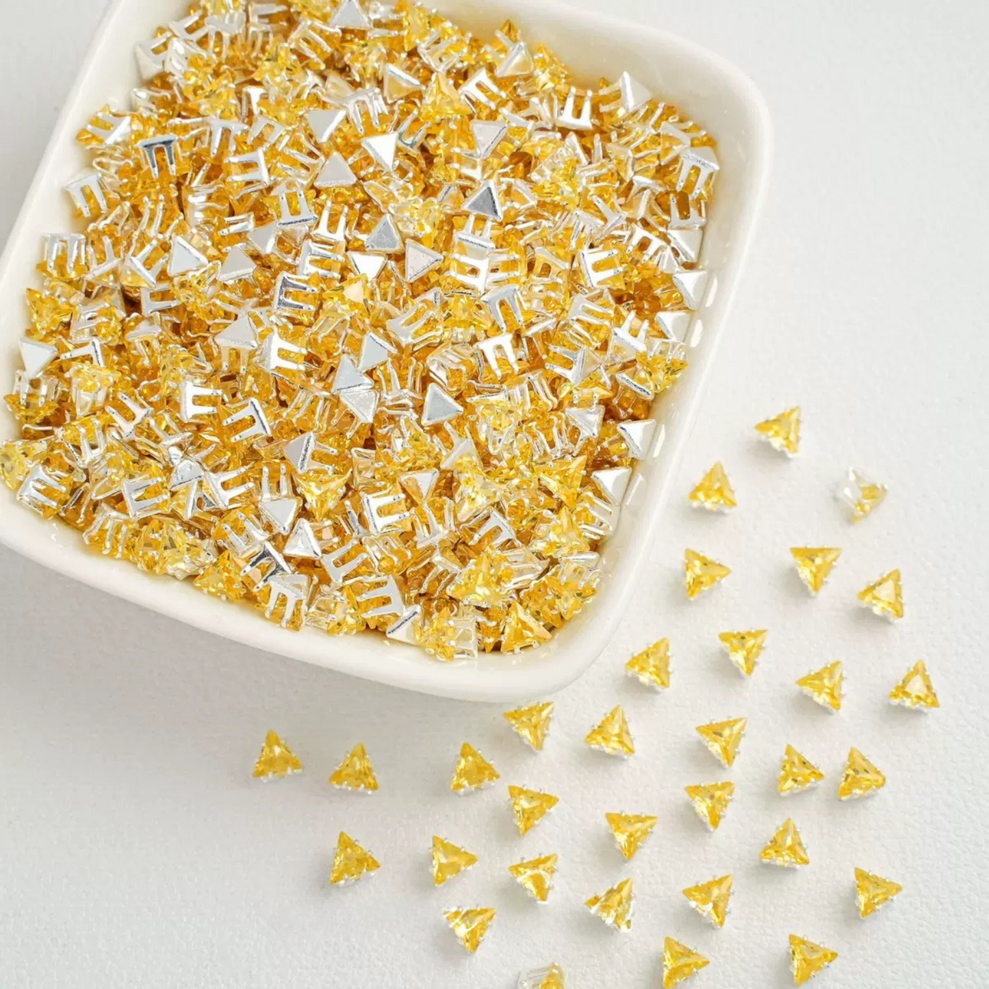 Yellow faceted triangle zirconia beads set on silver backing